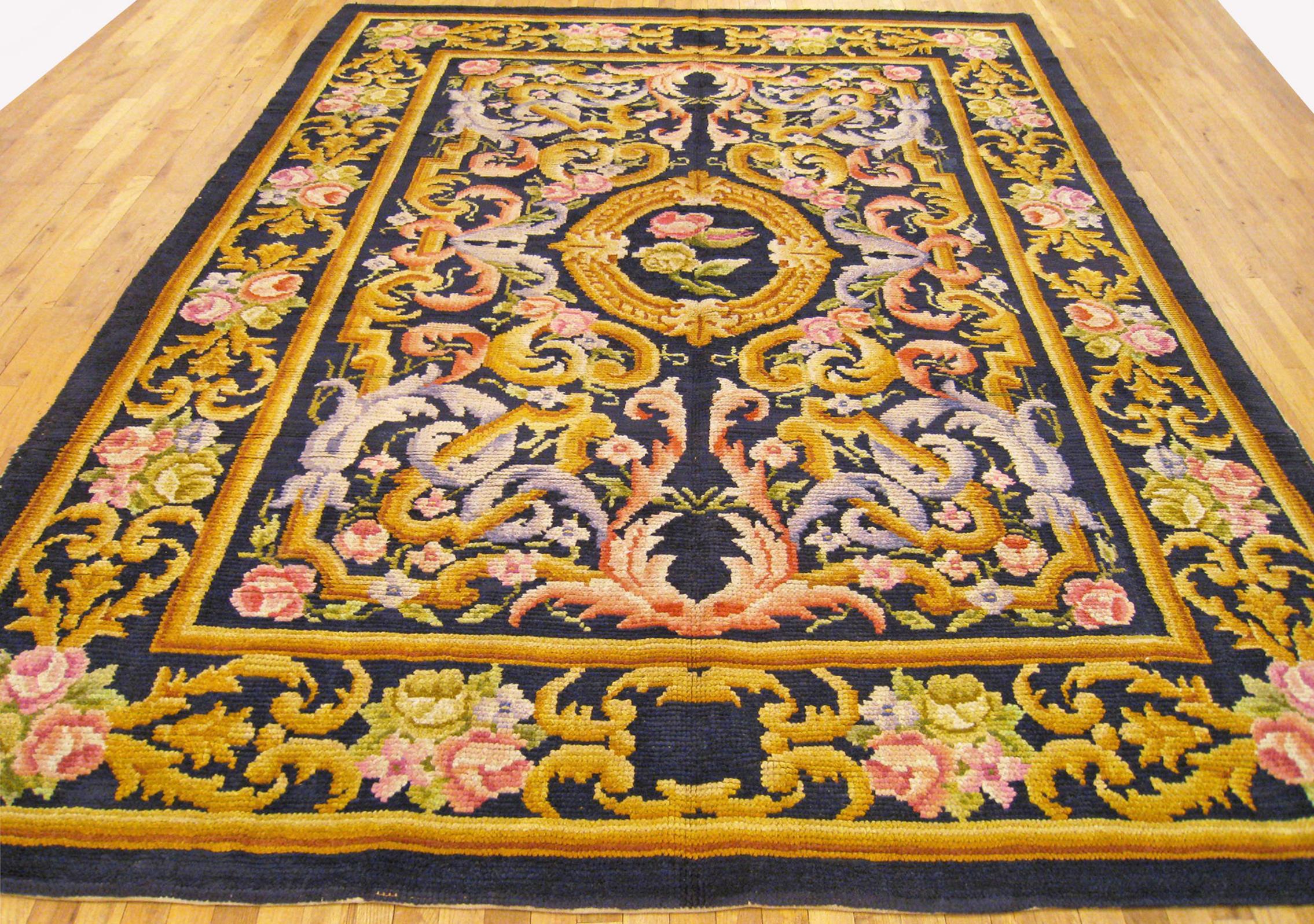 Vintage Spanish Savonnerie rug, Room size, circa 1930

A one-of-a-kind vintage Spanish Savonnerie oriental carpet, hand-knotted with soft wool pile. This lovely hand-knotted wool rug features a central medallion on the dark blue field, with a dark