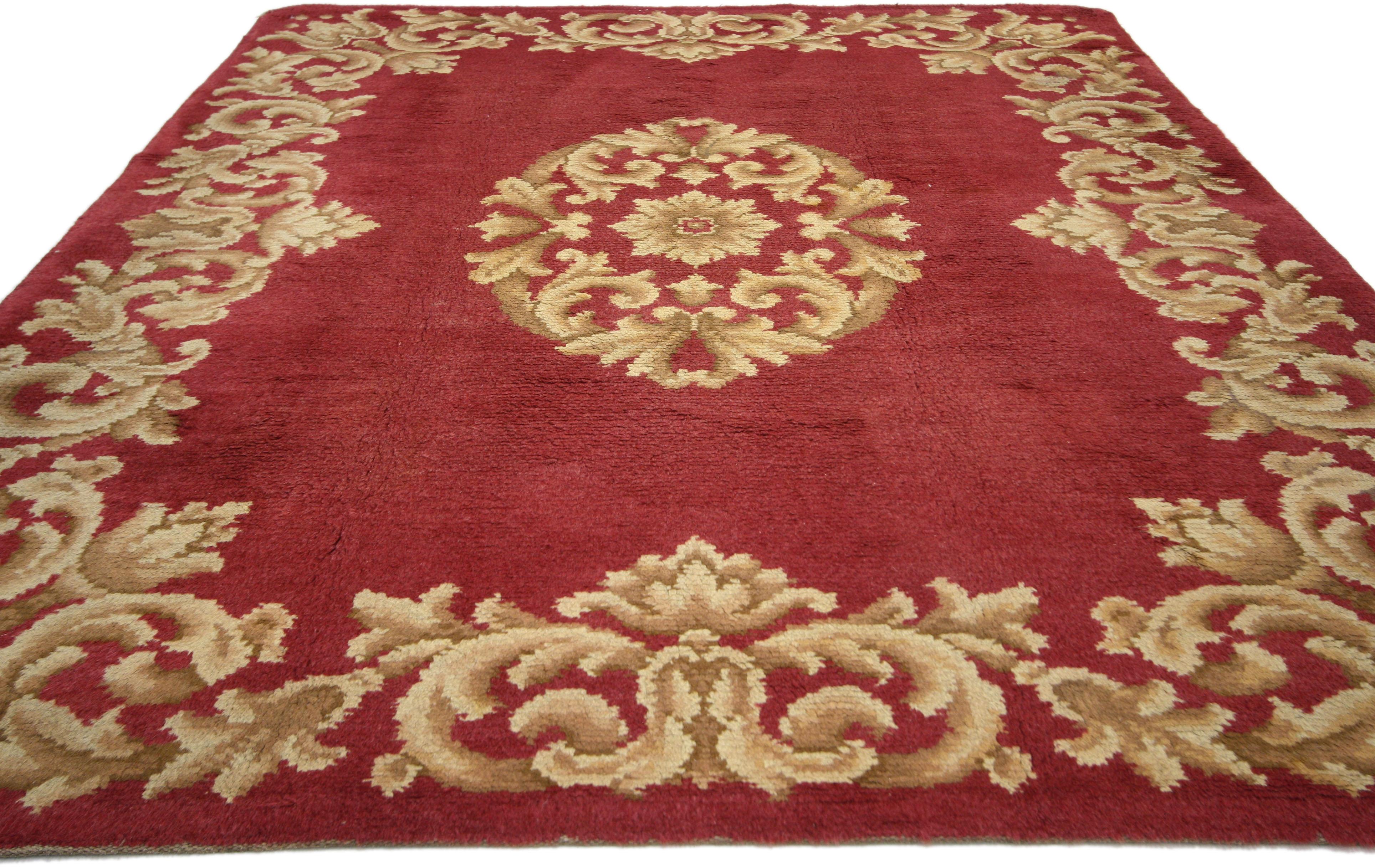 73073, vintage Spanish Savonnerie with Rococo style. Fit for a regal interior, this vintage Spanish Savonnerie carpet captivates with its bright red and golden hues and trompe l'oeil effect. On a ruby red backdrop, light colored scroll-work creates