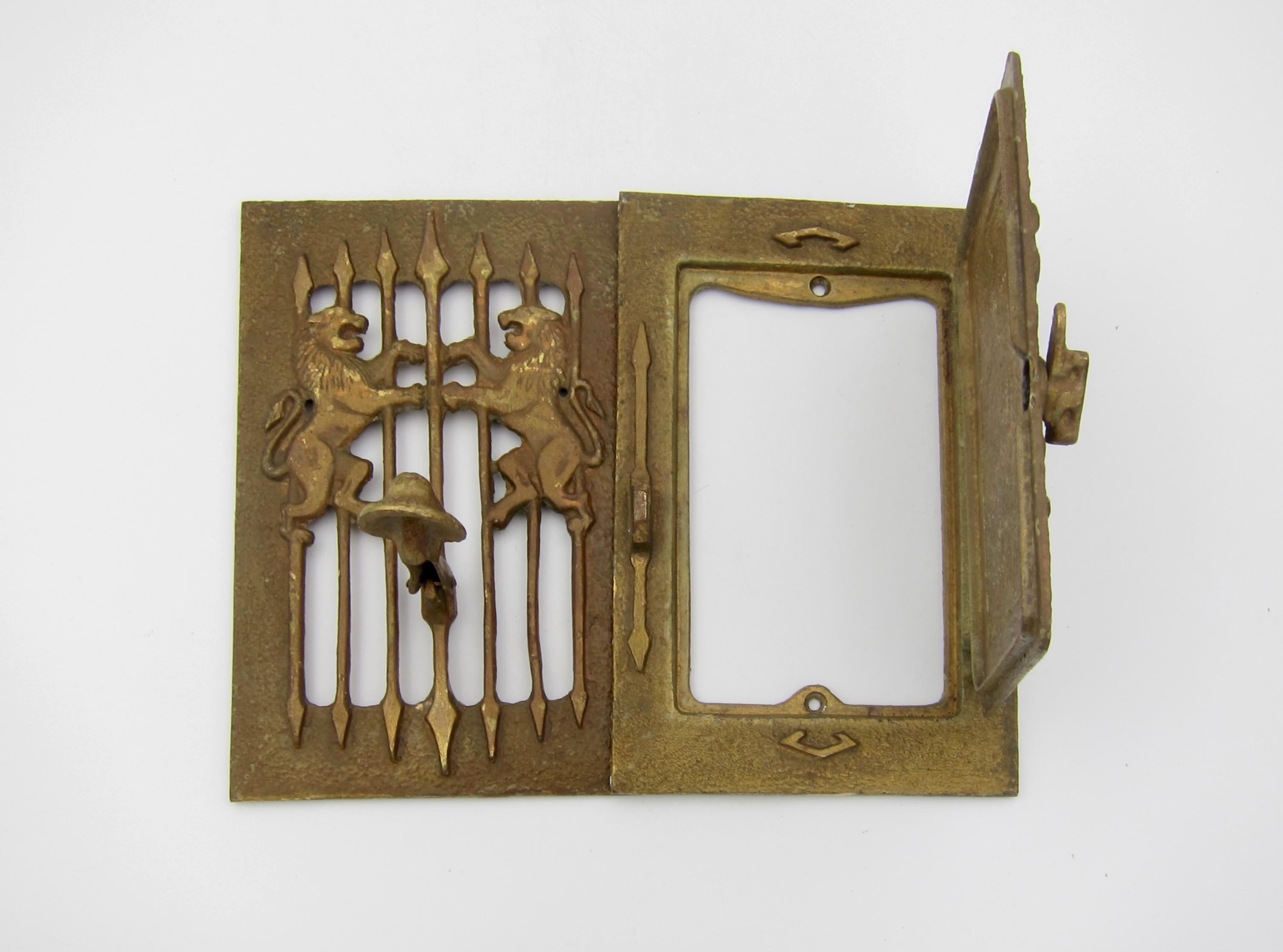 A two panel speakeasy door knocker and grill with a large inner peephole of rectangular shape that opens on side hinges and fastens closed. The ornate design of heavy cast metal was hand-finished with rivets securing the knocker on the front panel