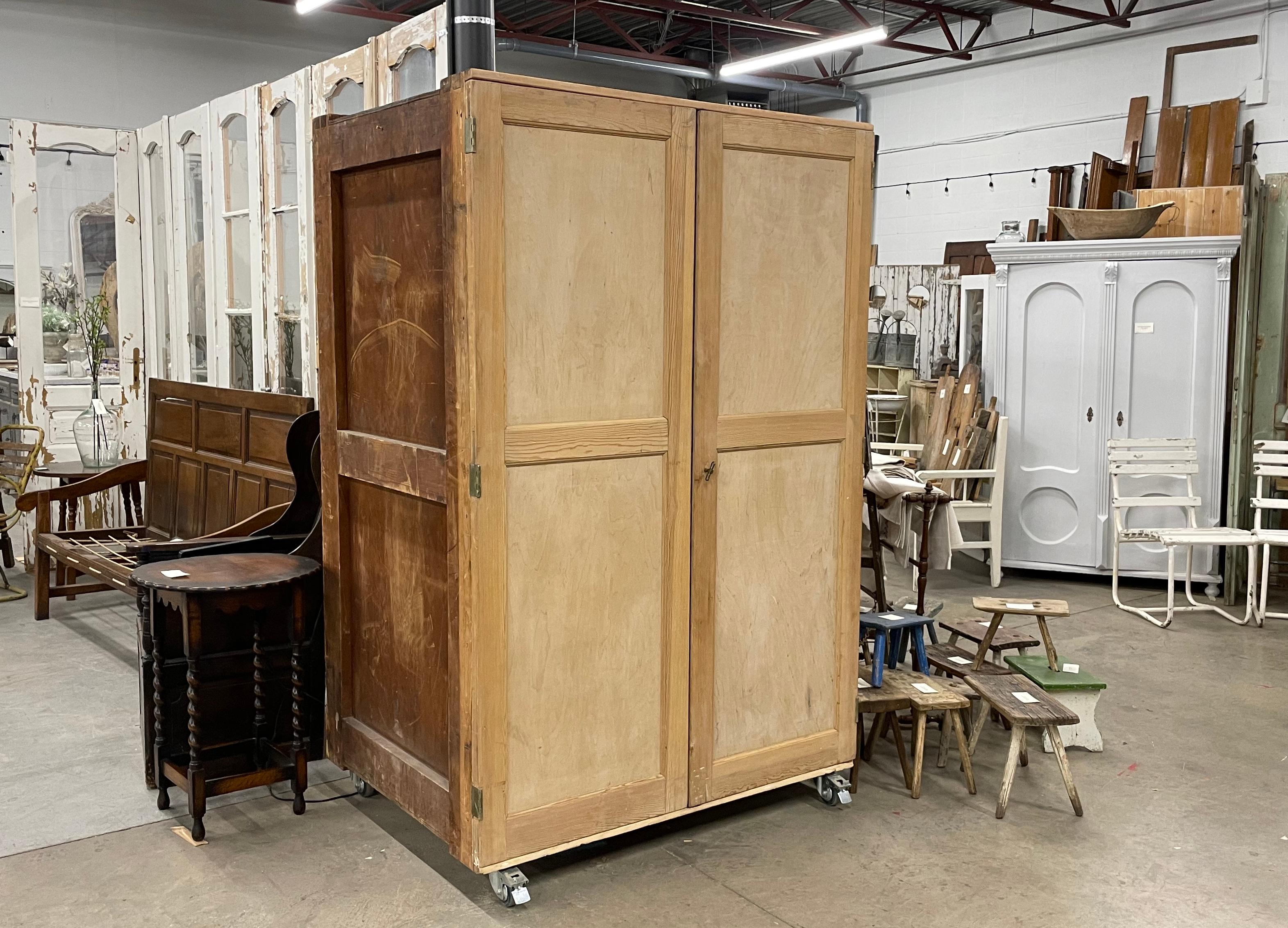 Substantial vintage wooden specimen cupboard on caster wheels, salvaged from the Natural History Museum, London, during its refurbishment between 2009-2012.

The frame of the cupboard is constructed with mortise and tenon joints. It has 12 large