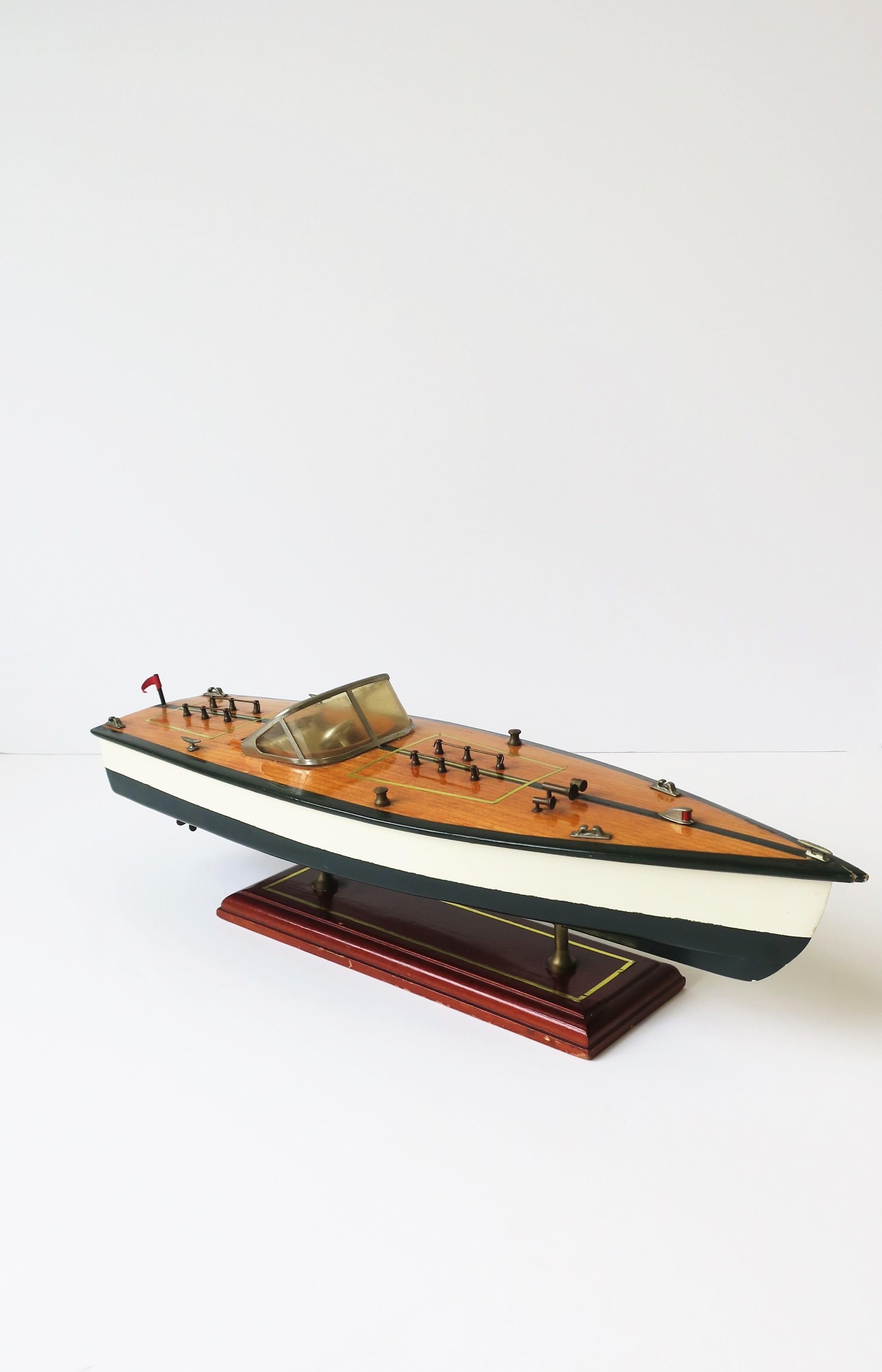 A vintage hand-made speed boat model, circa mid-20th century. A great model decorative object. Beautiful details including varnished mahogany wood deck, wrap around windshield, seating, steering wheel, deck cleats, exhaust pipe and propeller's,