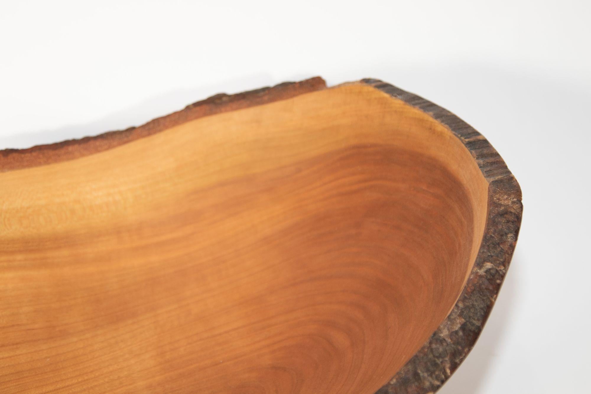 Vintage Spencer Peterson wooden cherry bowl in an oval shape with a natural live edge.

A luxurious hardwood with a satin grain and rich warm color, cherry wood is a symbol of spring, love and renewal. 
This bowl is sustainably sourced and up