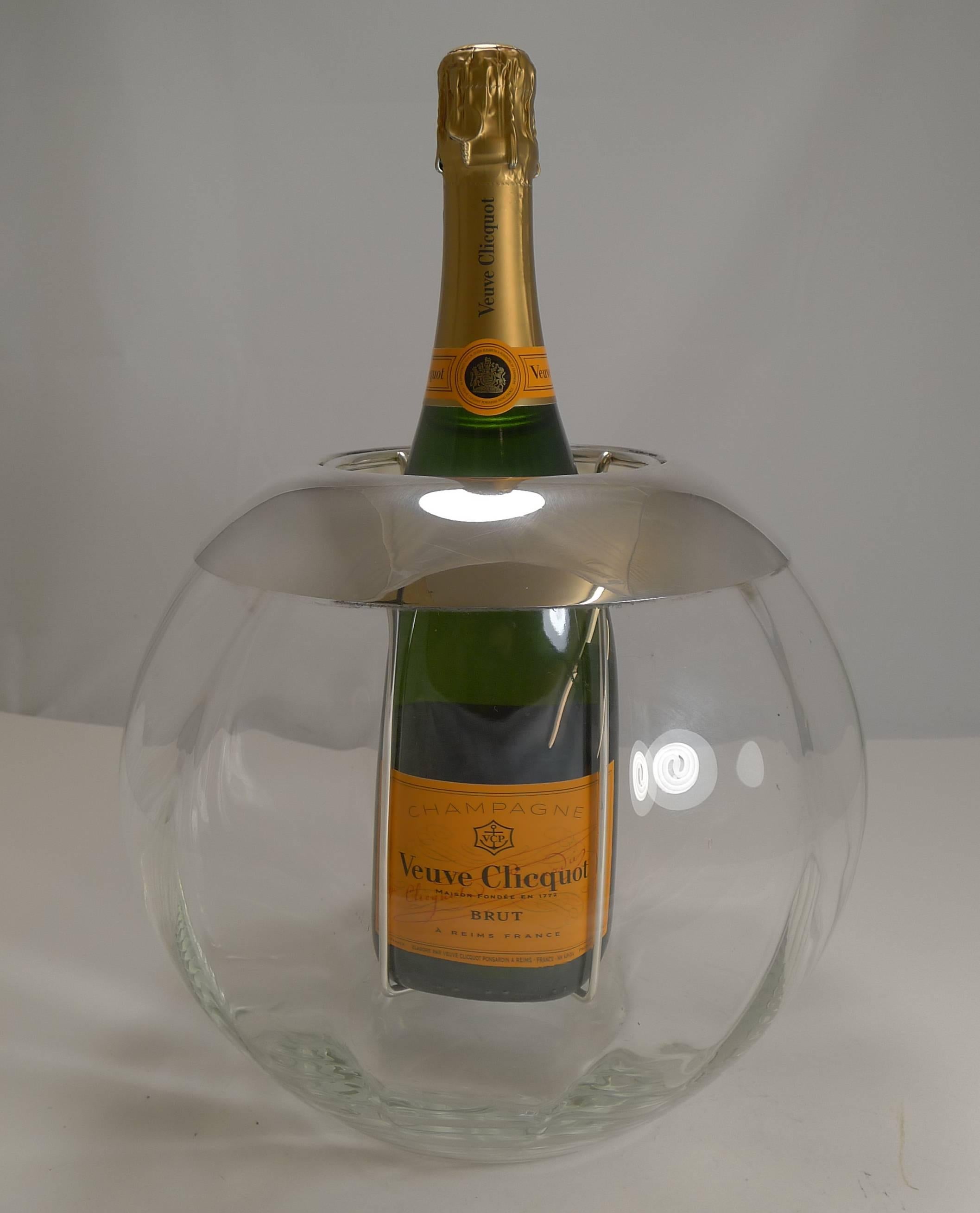 This is what everybody is looking for right now, this highly sought after Champagne or wine cooler dates to the mid-twentieth century and will be the star of your mid-century modern bar.

Made in a spherical form from glass, it resembles late