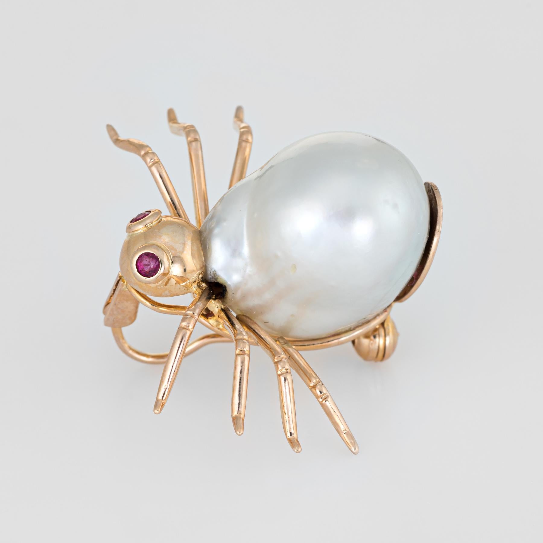 Finely detailed vintage spider brooch, crafted in 14 karat yellow gold.  

Two approx. 0.02 carat rubies are set into the eyes, accented with a 16mm x 13mm cultured baroque pearl in the body of the spider.    

The piece was made as a brooch yet it