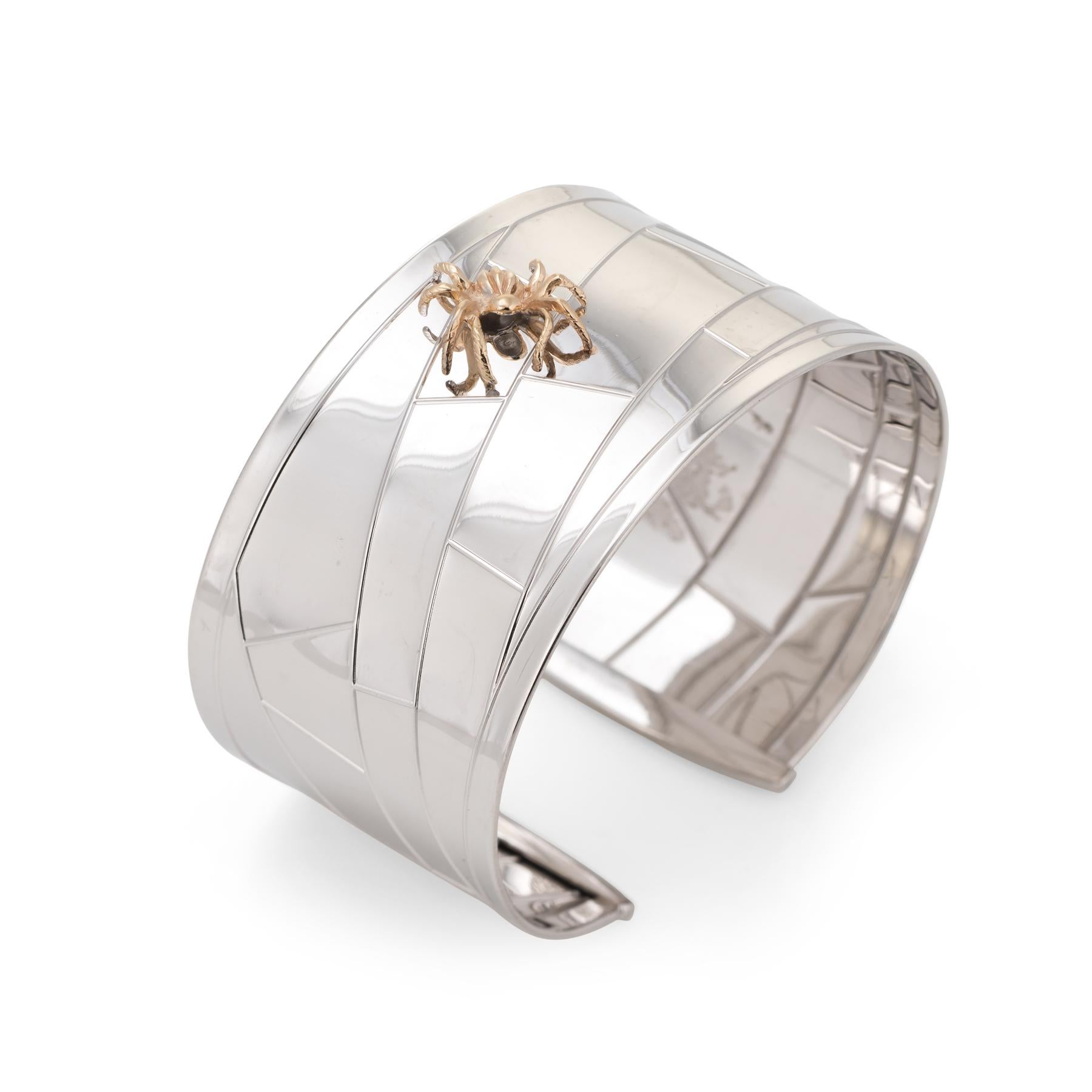 Stylish and finely detailed vintage cuff bracelet, crafted in 14 karat white gold. The spider is 14 karat yellow gold. 

The cuff is constructed in 14 karat white gold with a structured linear design to mimic a spiders web. The eight legged spider