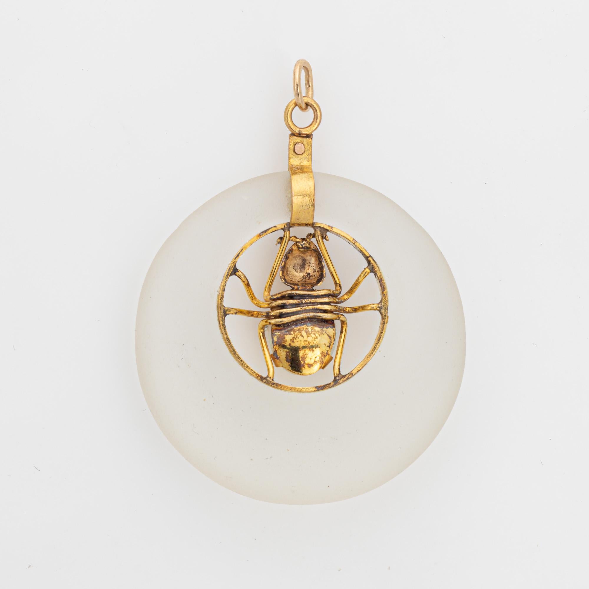 Finely detailed vintage spider pendant crafted in 14k yellow gold (circa 1960s to 1970s).  

One cabochon opal measuring 8mm x 6mm. The camphor glass measures from 5mm to 10mm wide and is 7mm thick. The opal and camphor glass are in very good