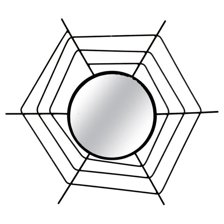 1960s Italian Mid-Century Modern Wall Mirror with Black “Spider Web” Frame

Unusual shpaed 1960s vintage wall mirror designed with a unique spider-net shape made from tubular iron. The intricate ironwork surrounding the mirror gives it a dynamic yet