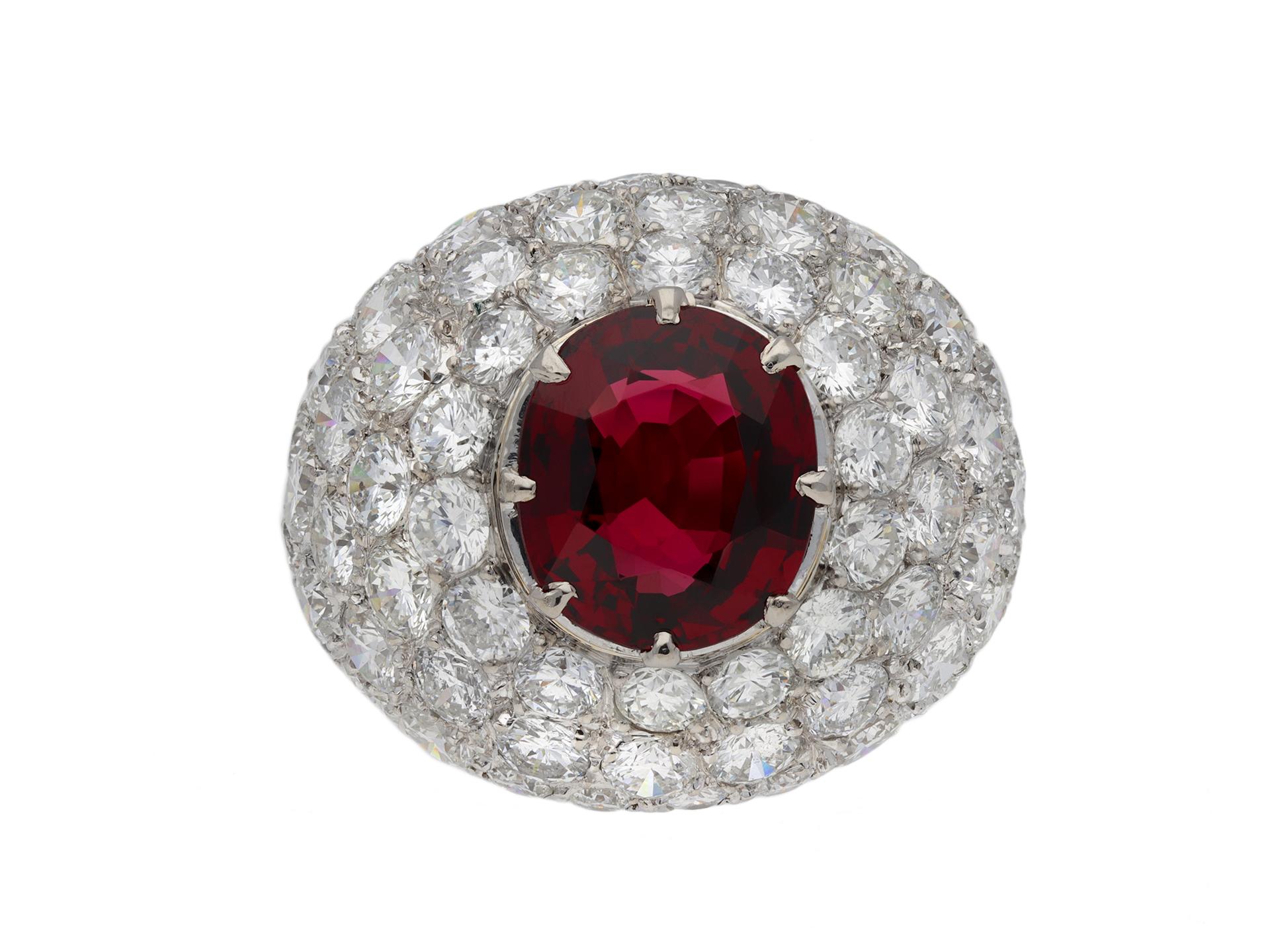 Ceylon spinel and diamond cocktail ring. Centrally set with a cushion shape old cut natural unenhanced spinel in an open back claw setting with an approximate weight of 3.40 carats, surrounded by seventy four round old cut diamonds in open back