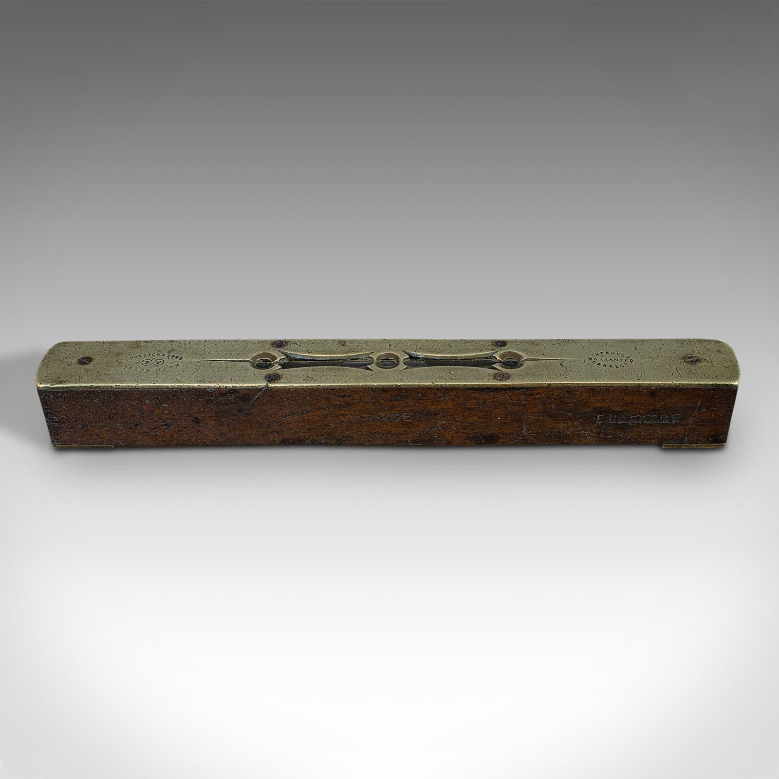 This is a vintage spirit level. An English, rosewood and brass instrument by Preston and Sons, dating to the mid-20th century, circa 1930.

Attractive craftsman's level
Displays a desirable aged patina
Body in rosewood with rich russet