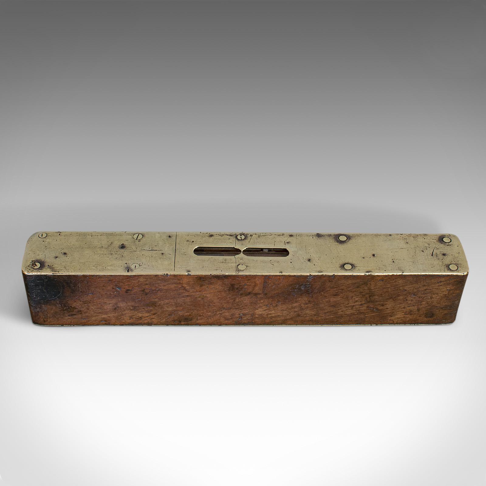 This is a vintage spirit level. An English, Rosewood and craftsman's instrument, dating to the mid-20th century, circa 1950.

Period appeal with quality finish
Displays a desirable aged patina
Body in rosewood shows fine grain interest
Brass
