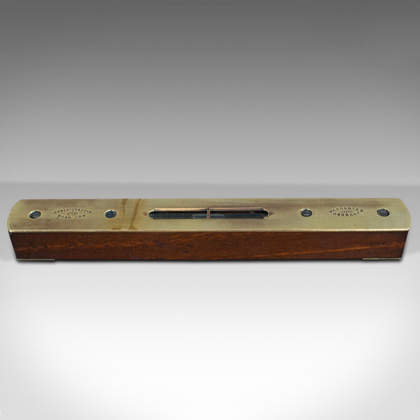 This is a vintage spirit level. An English, walnut and brass instrument by Preston and Sons, dating to the mid-20th century, circa 1930.

Attractive craftsman's level
Displays a desirable aged patina
Body in walnut shows rich russet