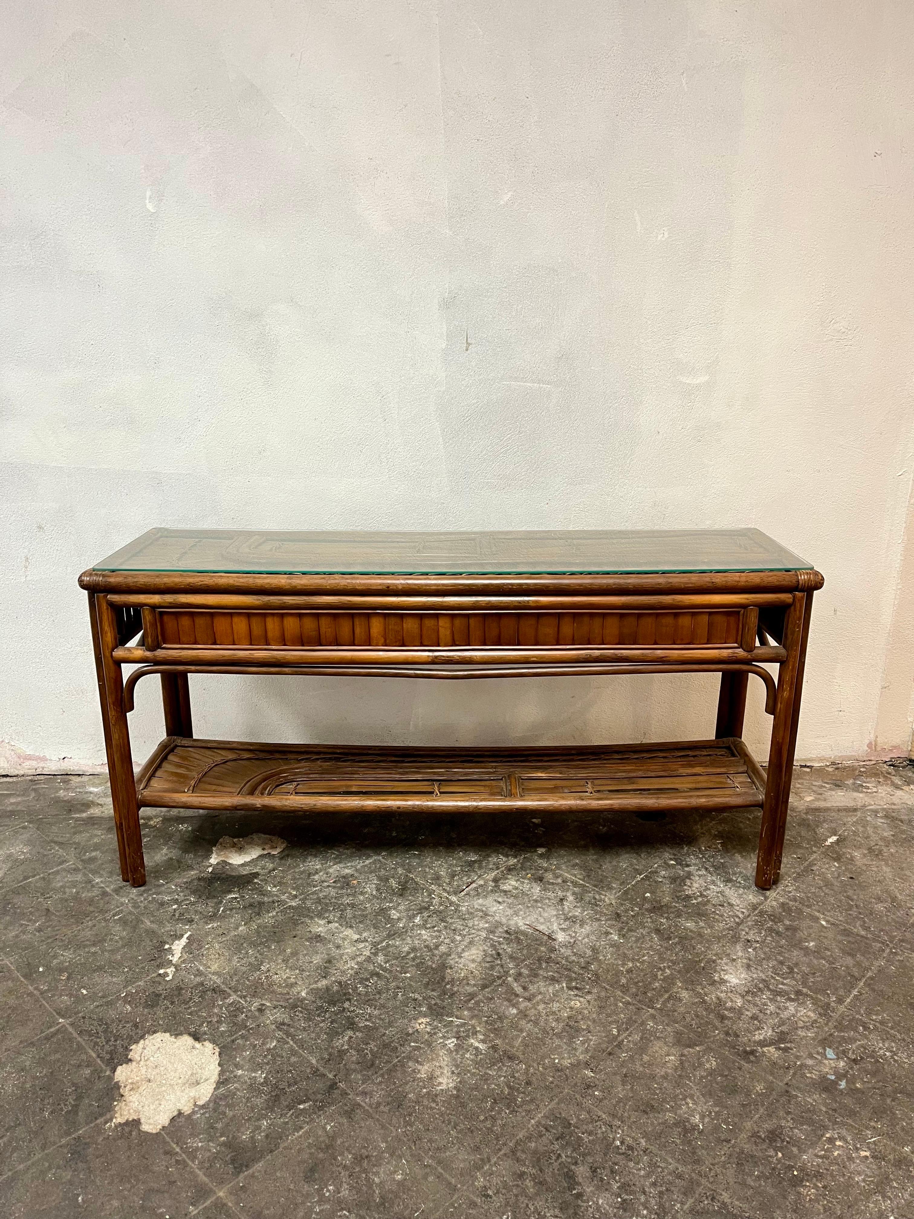 Beautiful console or sofa table with split bamboo detail. Lovely fanning of bamboo and interwoven lacing. Screams Gabriella Crespi Rising Sun styling. Solid and sturdy with glass top.
Curbside to NYC/Philly $350