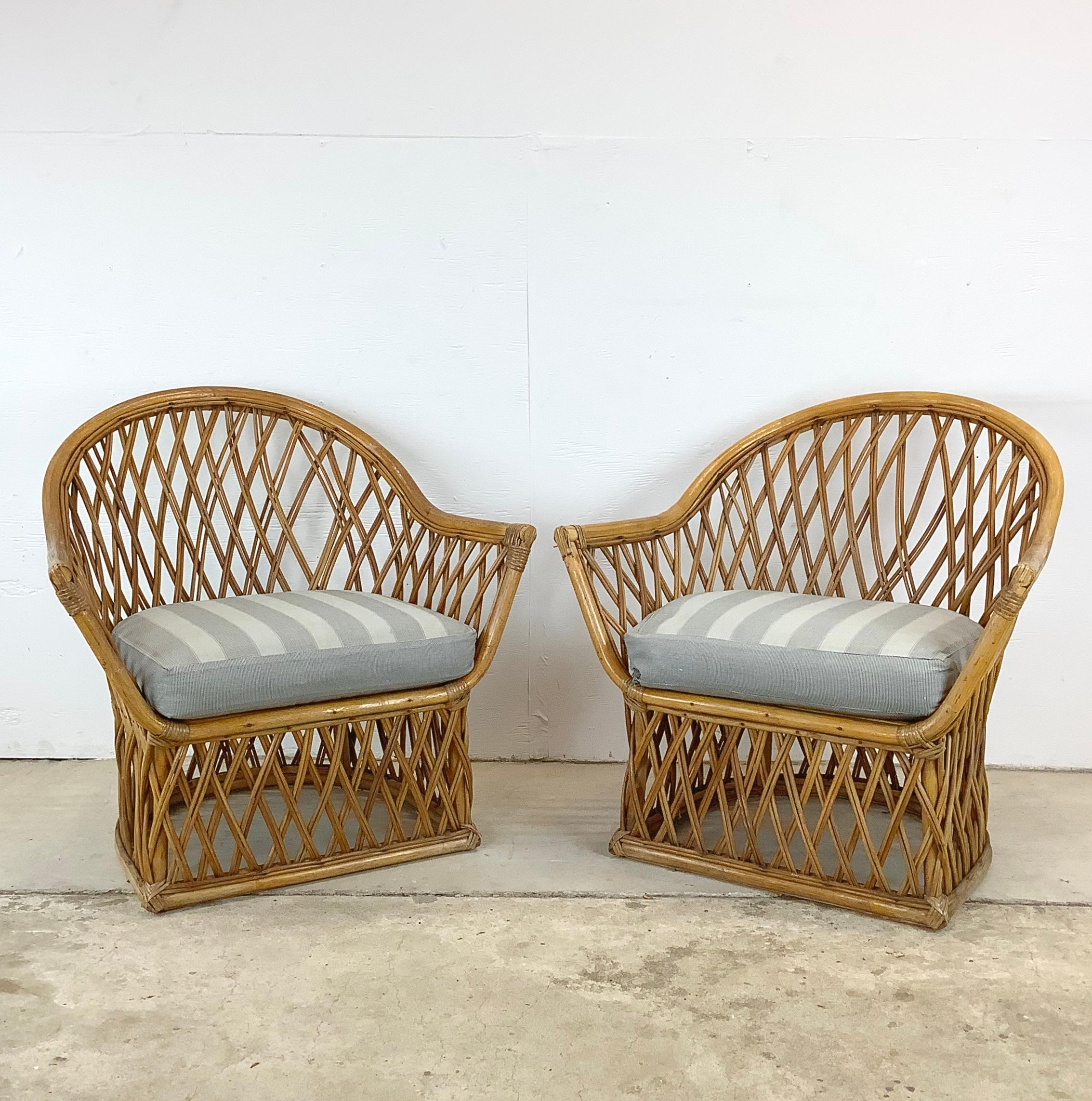 Picture yourself by the seaside, the gentle ocean breeze rustling through the palm fronds, the sun casting its warm embrace, and you, comfortably nestled in this pair of vintage Coastal Rattan Lounge Chairs. These chairs aren't just pieces of