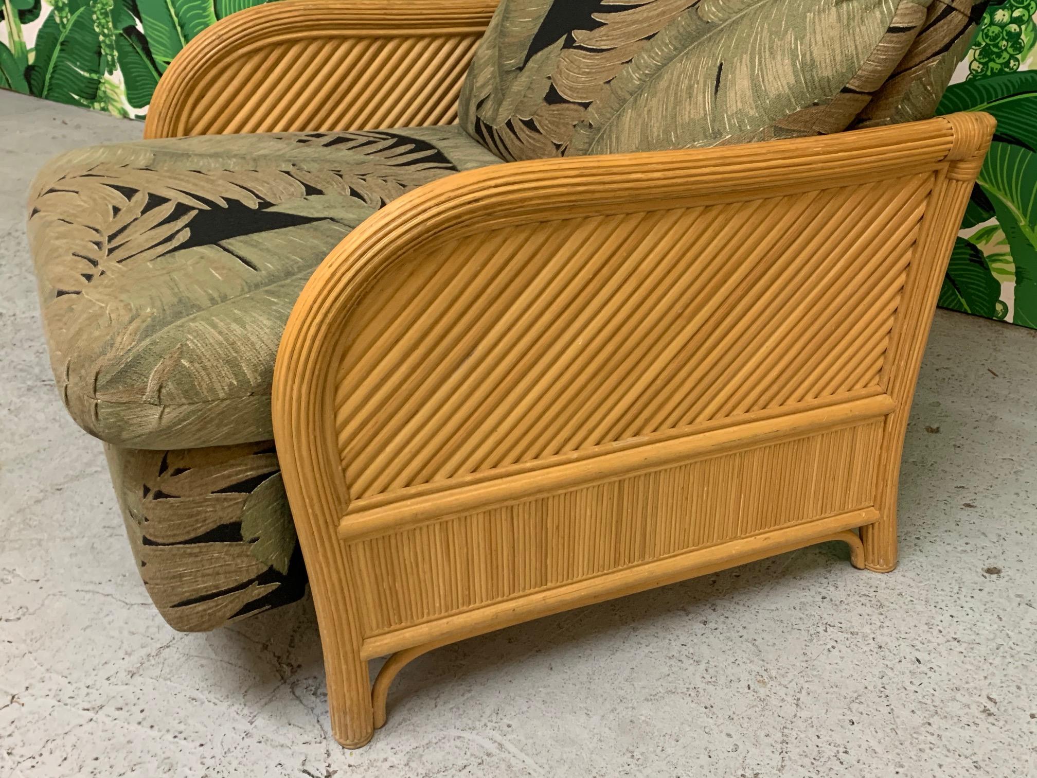 Vintage recliner chair features rattan sides in pencil reed veneer and a tropical palm print upholstery. Very good condition, structurally sound, perfect reclining mechanism, and only very minor imperfections consistent with age.
Measures: Arm