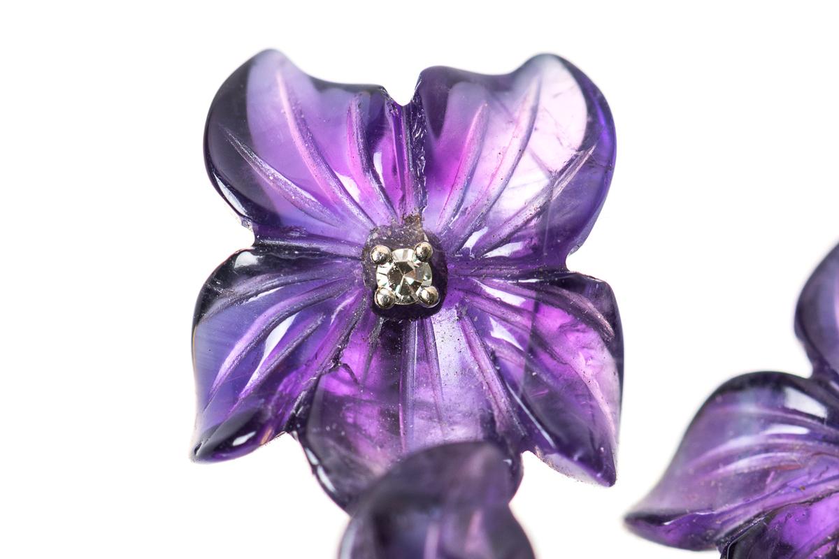 A 14 karat yellow gold mounted spray of violets brooch with five carved Amethyst violet flowers, each with a central diamond. Below are three carved Nephrite leaves, the reverse stamped with Austrian marks. 
Size; 55mm height,  40mm width.
1950's