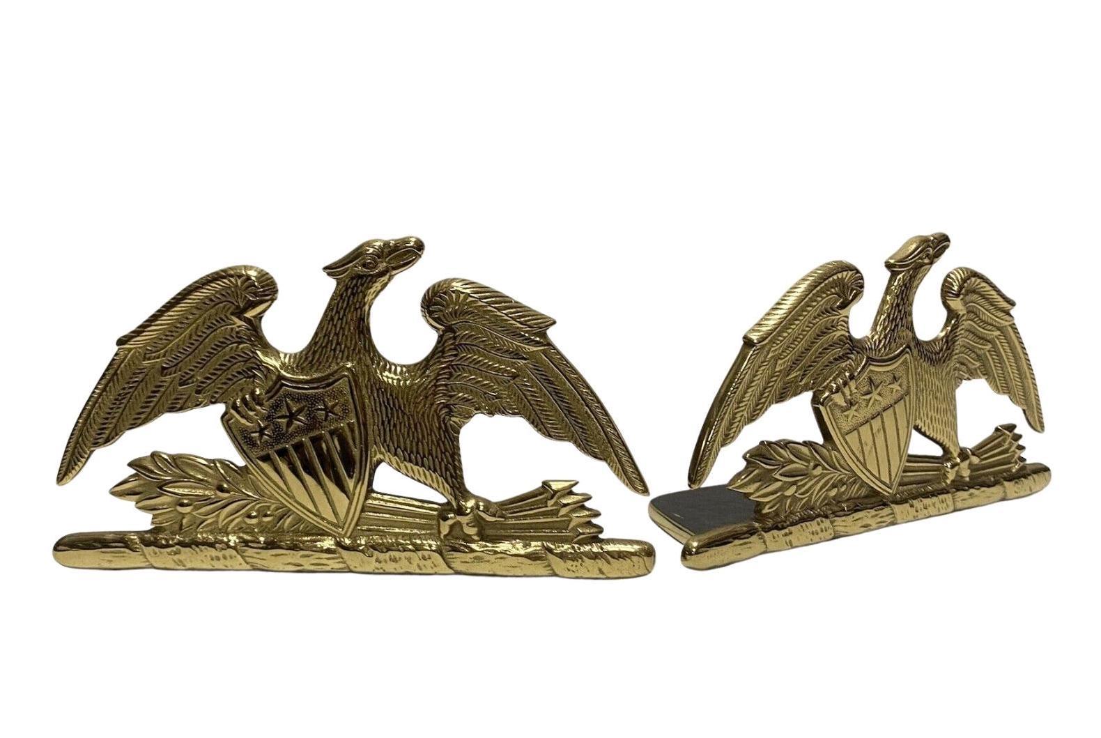 Offered is a beautiful pair of spread-wing eagle bookends by Virginia Metalcrafters, stamped 1952. The eagle is shown with its wings fully spread and a laurel branch and bundle of arrows clutched in its left talon. The eagle clutches a Union shield