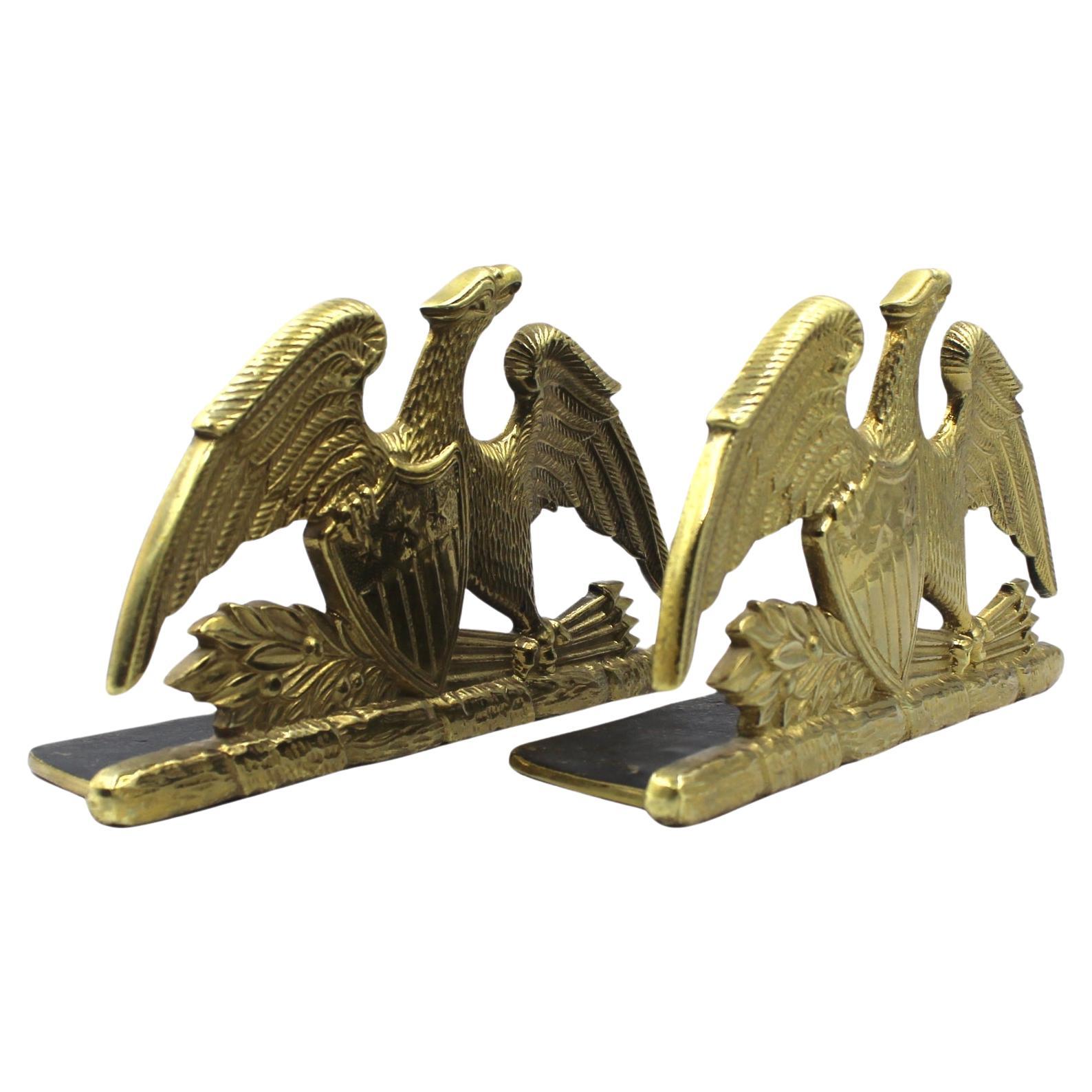 Offered is a beautiful pair of spread-wing eagle bookends by Virginia Metalcrafters, stamped 1952. The eagle is shown with its wings fully spread and a laurel branch and bundle of arrows clutched in its left talon. The eagle clutches a Union shield