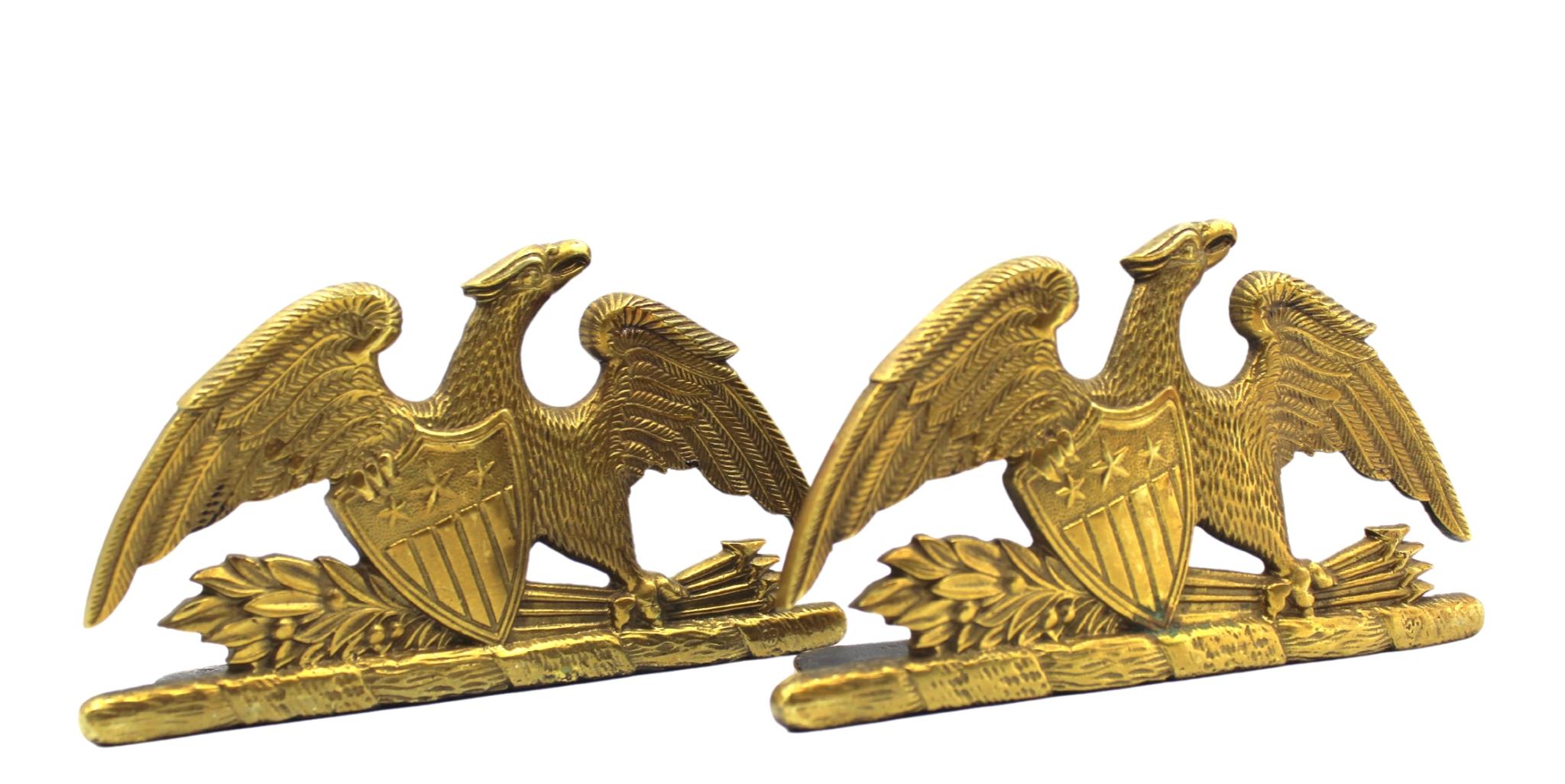 Offered is a beautiful pair of spread-wing eagle bookends by Virginia Metalcrafters, stamped 1952. The eagle is shown with its wings fully spread and a laurel branch and bundle of arrows clutched in its left talon. The eagle clutches a Union shield