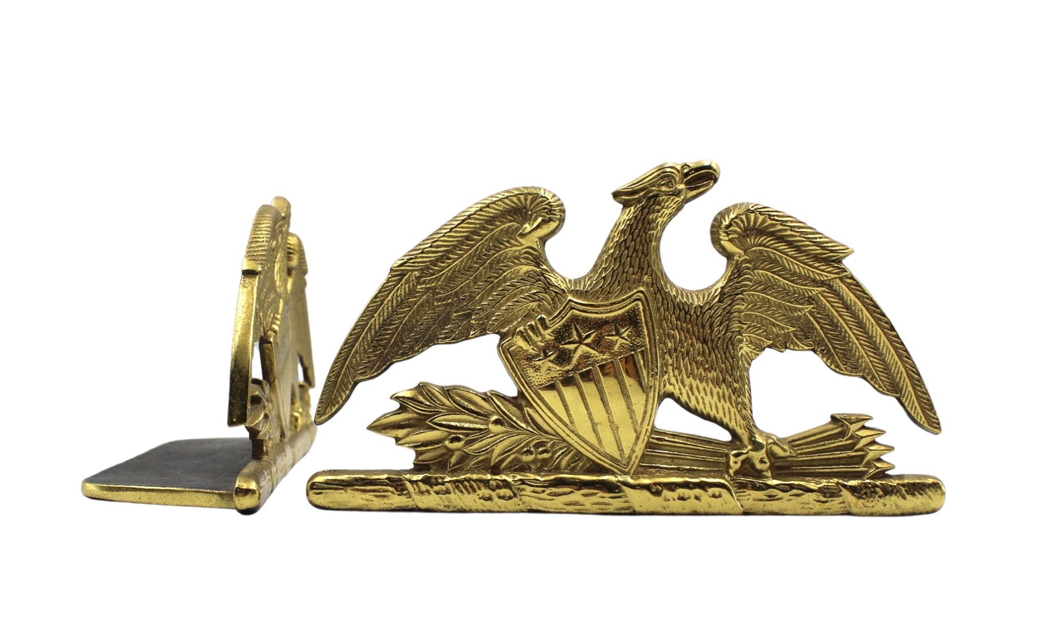 Offered is a beautiful pair of spread-wing eagle bookends by Virginia Metalcrafters, stamped 1952. The eagle is shown with its wings fully spread and a laurel branch and bundle of arrows clutched in its left talon. The eagle clutches a Union shield
