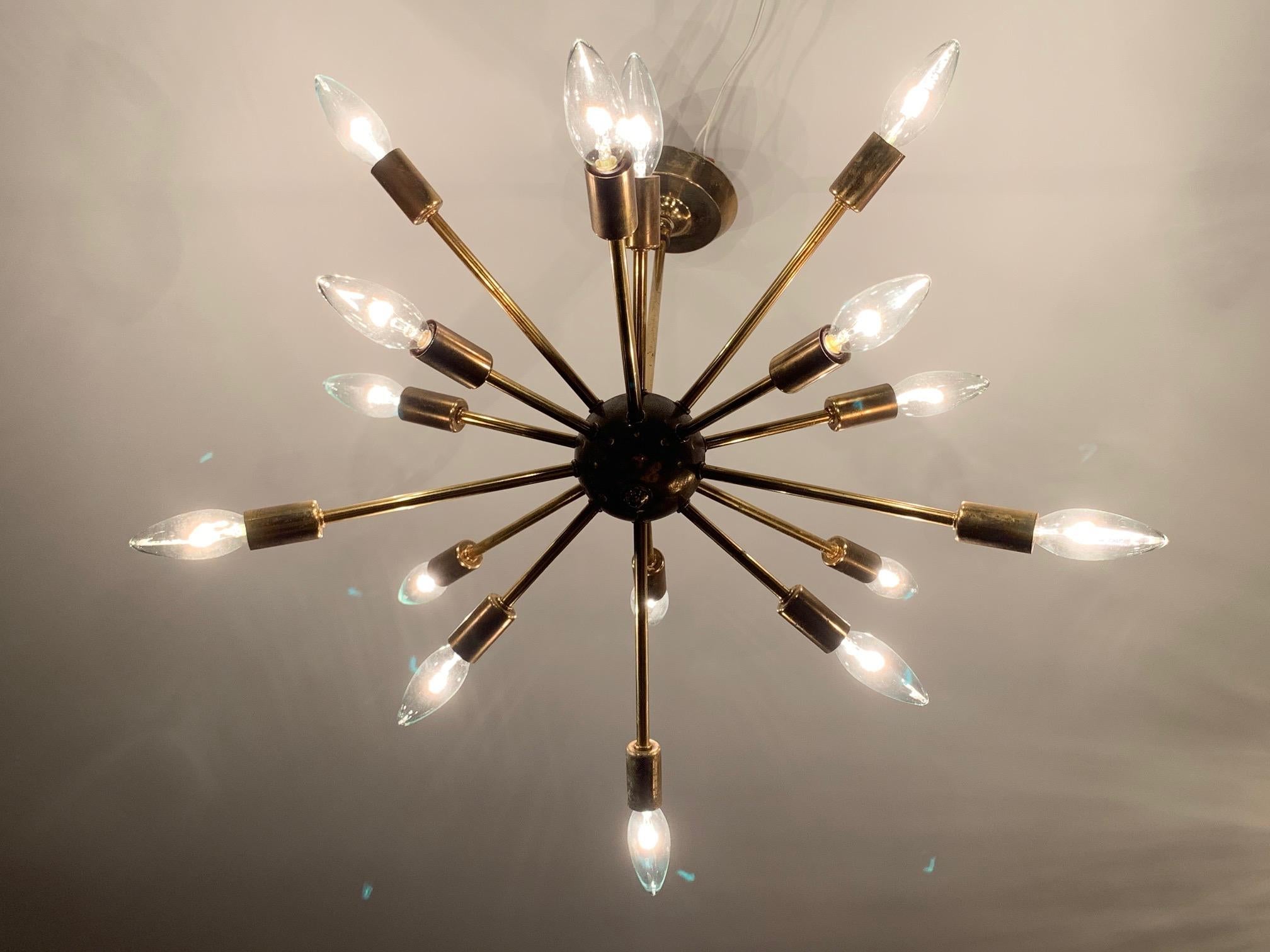 A classic sputnik, brass chandelier, 16 arms. Original canopy, original condition with nice patina! A real midcentury look that never goes out of style.
  
