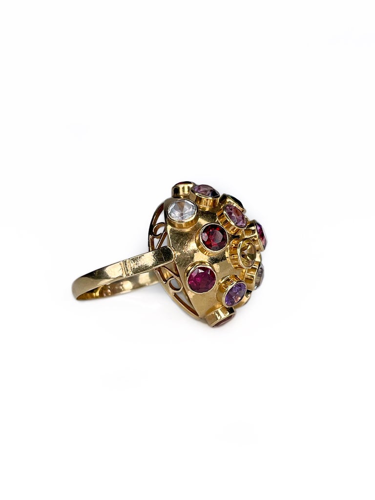 It is an iconic “Sputnik” design vintage dome ring crafted in 18K yellow gold. It features semi precious gems: amethysts, aquamarines, garnets, citrines, tourmalines.

The so-called 