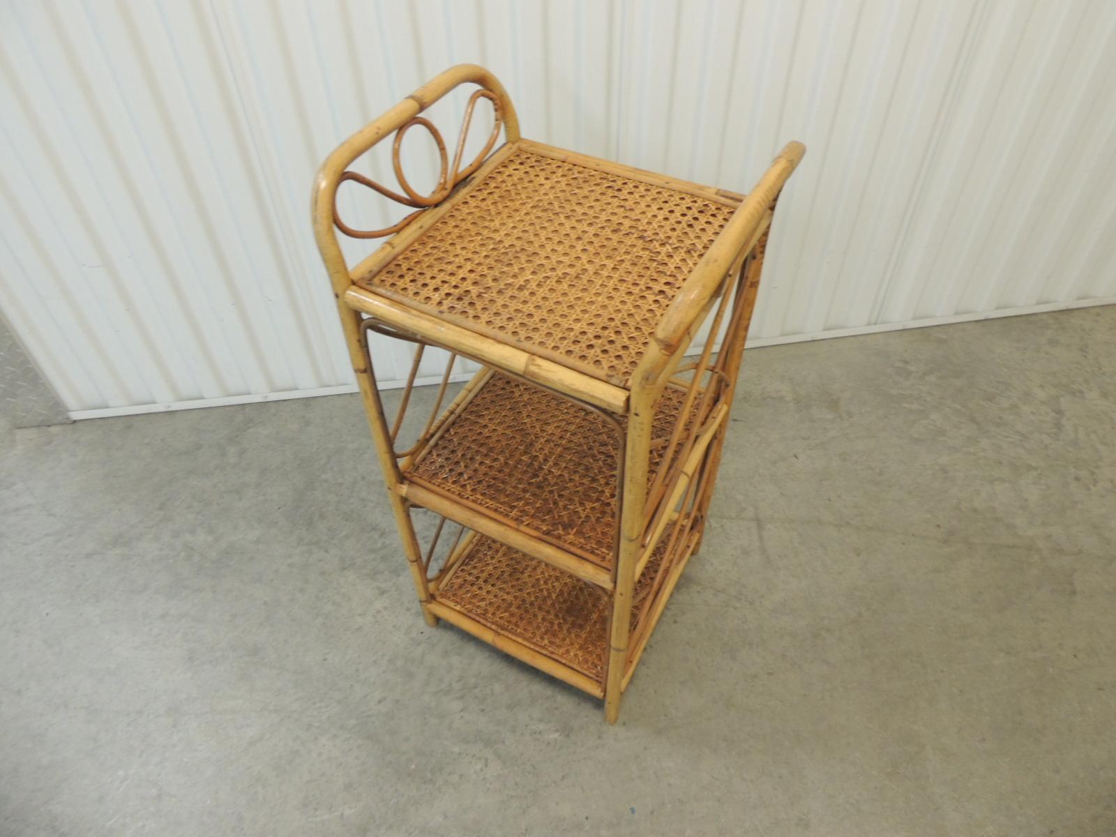 Vintage square bamboo étagère.
Square shelves with lattice design sides and rounded top handles.
Rattan woven details on the shelves.
Measures: 12 x 12 x 27.5 H.
