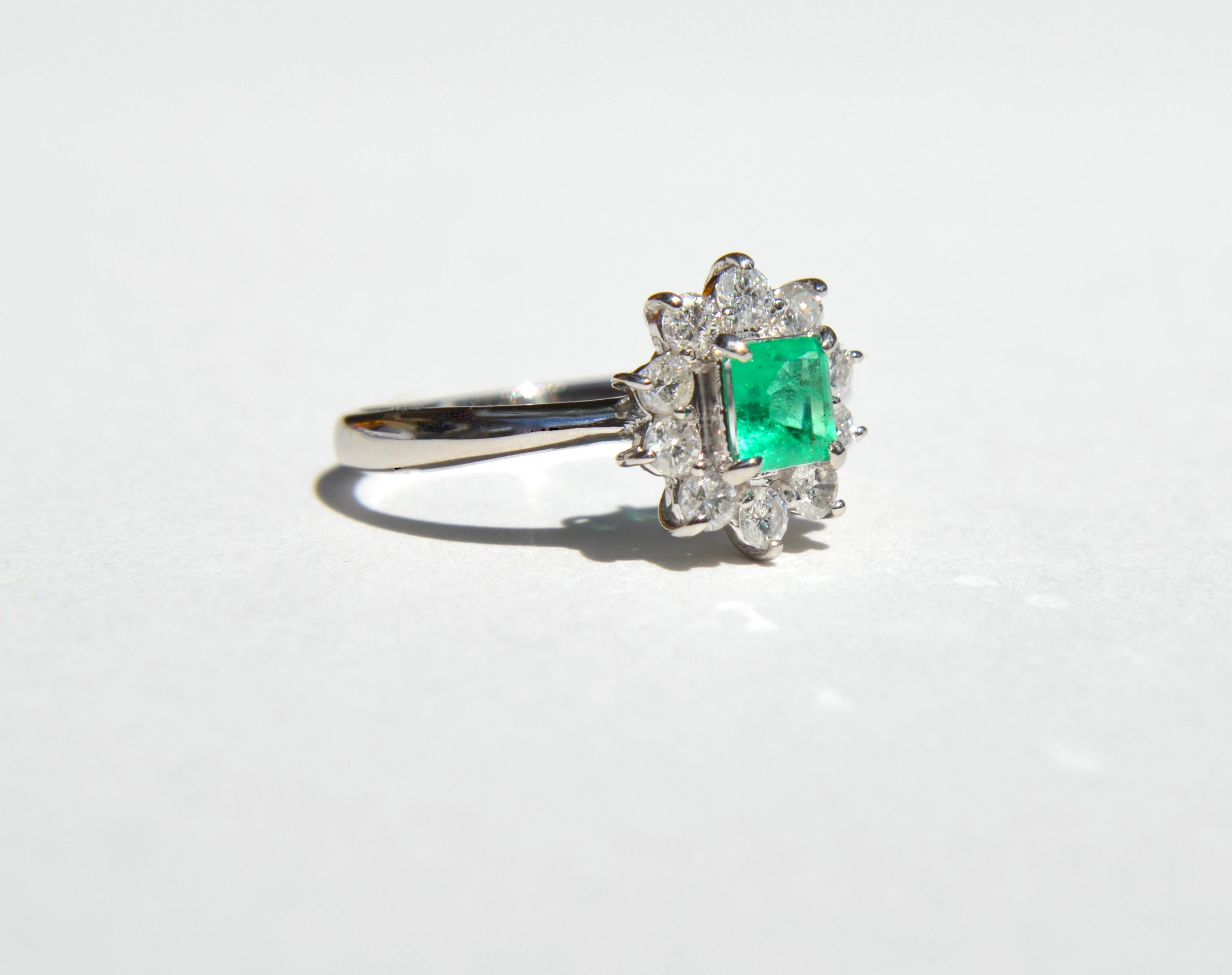 Gorgeous vintage midcentury era 1960s .39 carat natural Colombian Emerald square cut ring with round cut diamond halo set in solid platinum. Size 4.5, can be easily resized by a jeweler. Marked and tested as Pt900 for solid platinum. In very good