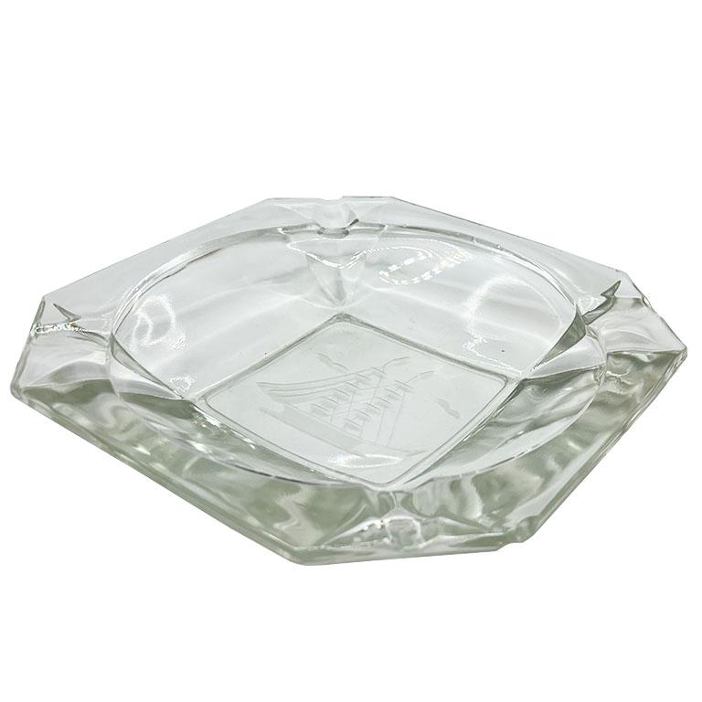 A large vintage glass cigar ashtray with an etched sailing motif. This nautical catchall will be great on a coffee table or side table. Fill it with odds and ends or use it as an ashtray. The piece is square with flat corners for cigars. The bottom