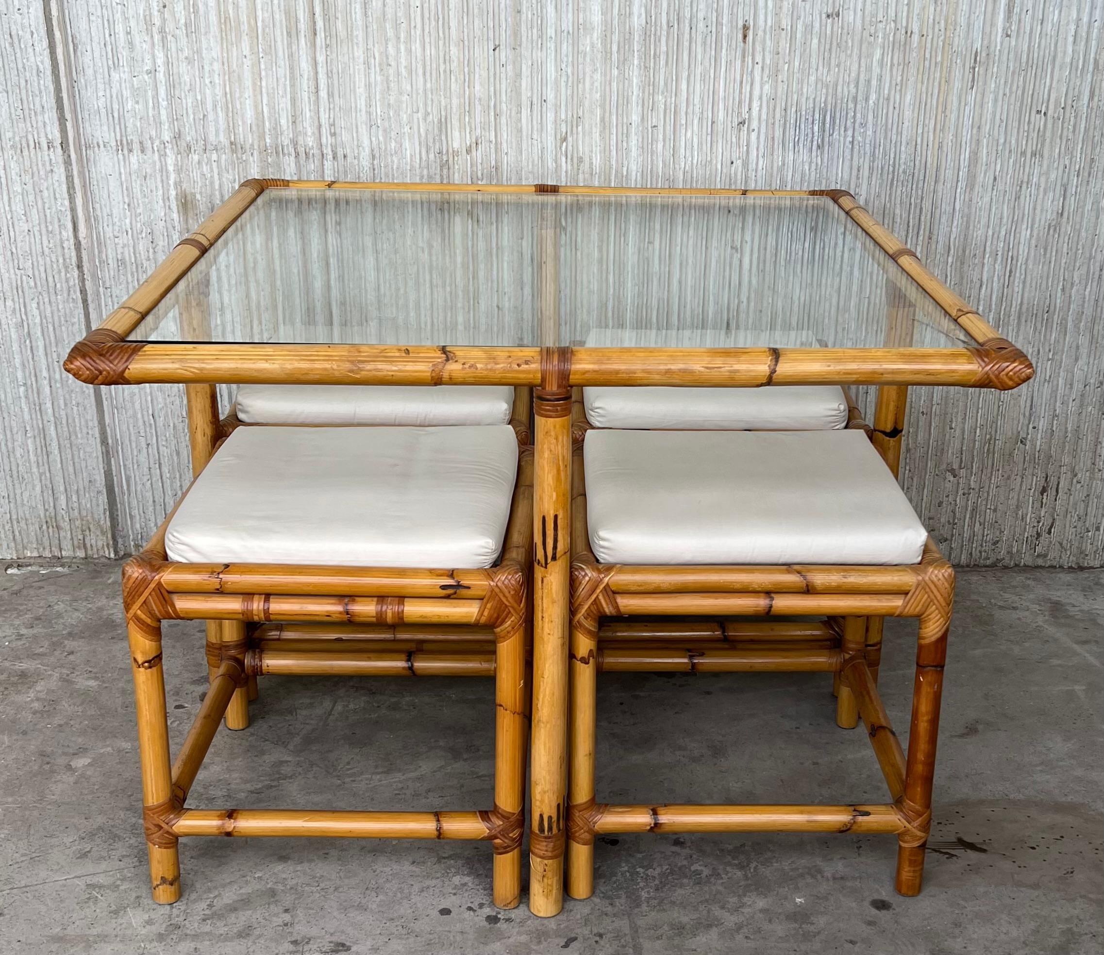 Vintage square McGuire style bamboo and glass dining table with four stools.

Each stool is 15.75 x 15.75 in.
 