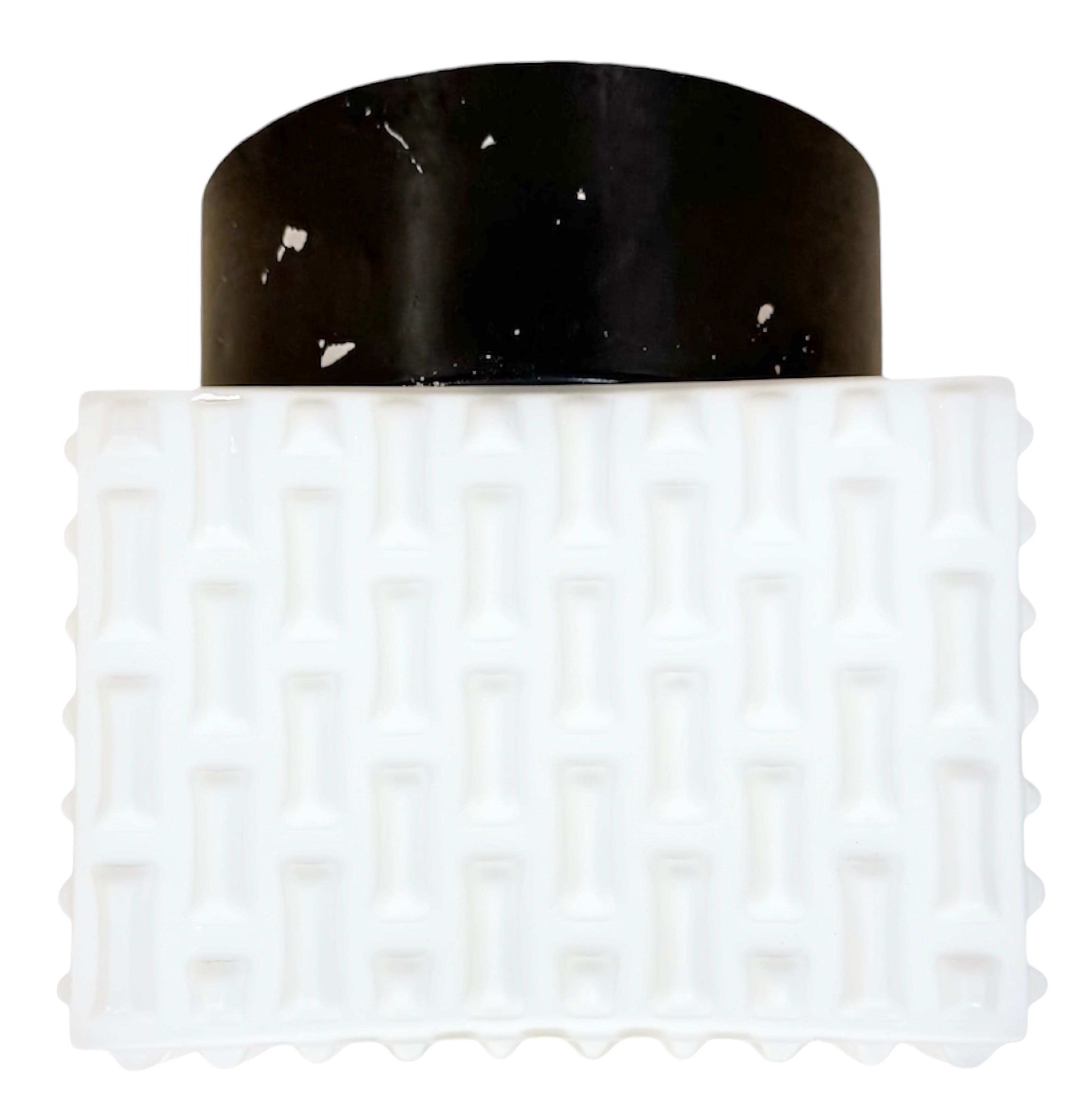 Vintage Industrial wall or ceiling lamp made in former Czechoslovakia during the 1970s. Was used in factory offices and corridors. It features a metal back and an embossed milk glass cover. The socket requires standard E 27/ E26 light bulbs. The