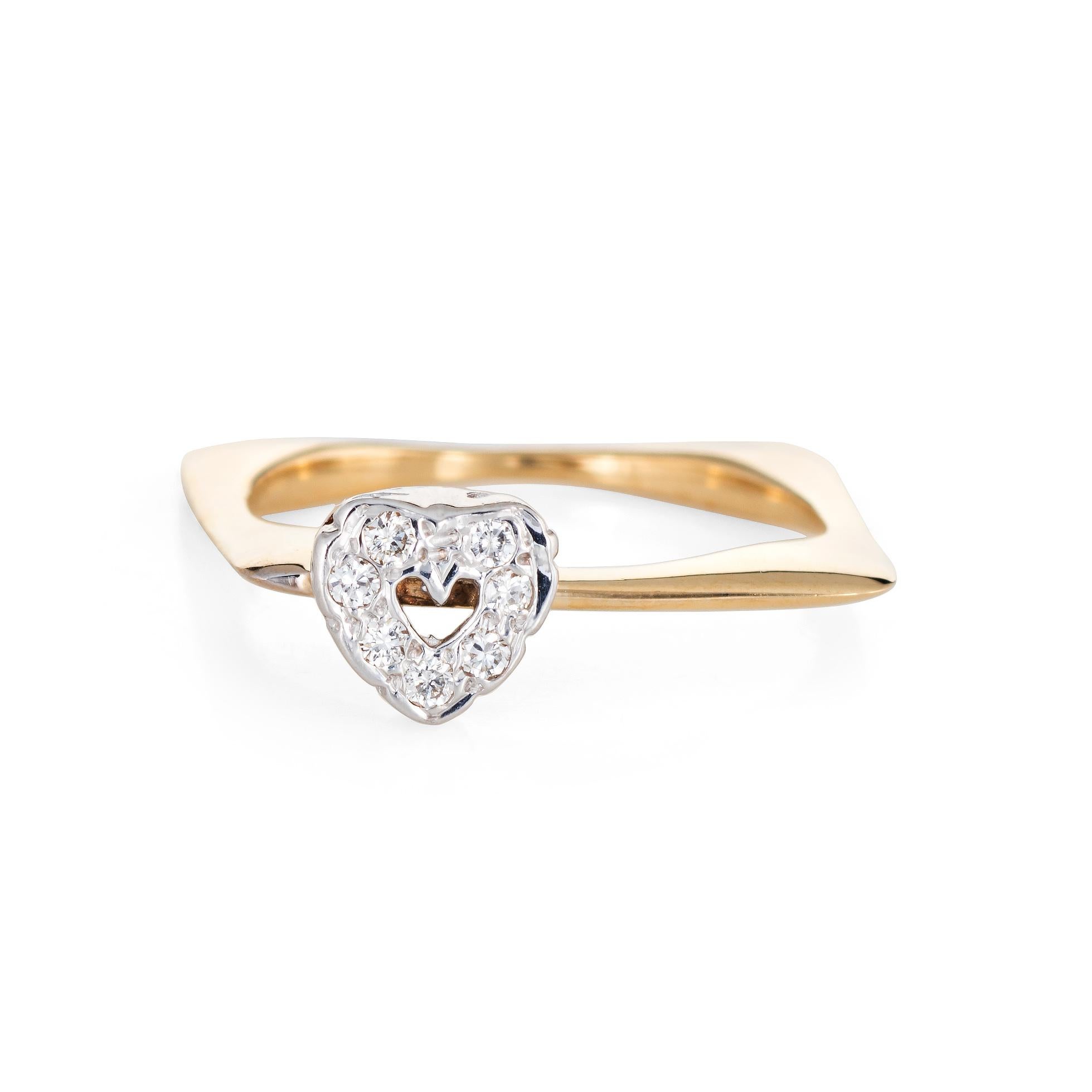 Distinct & stylish vintage square band crafted in 14 karat yellow gold (circa 1970s to 1980s). 

Diamonds are set into the heart shaped mount and total an estimated 0.07 carats (estimated at G-H color and VS2 clarity).

The charming square band