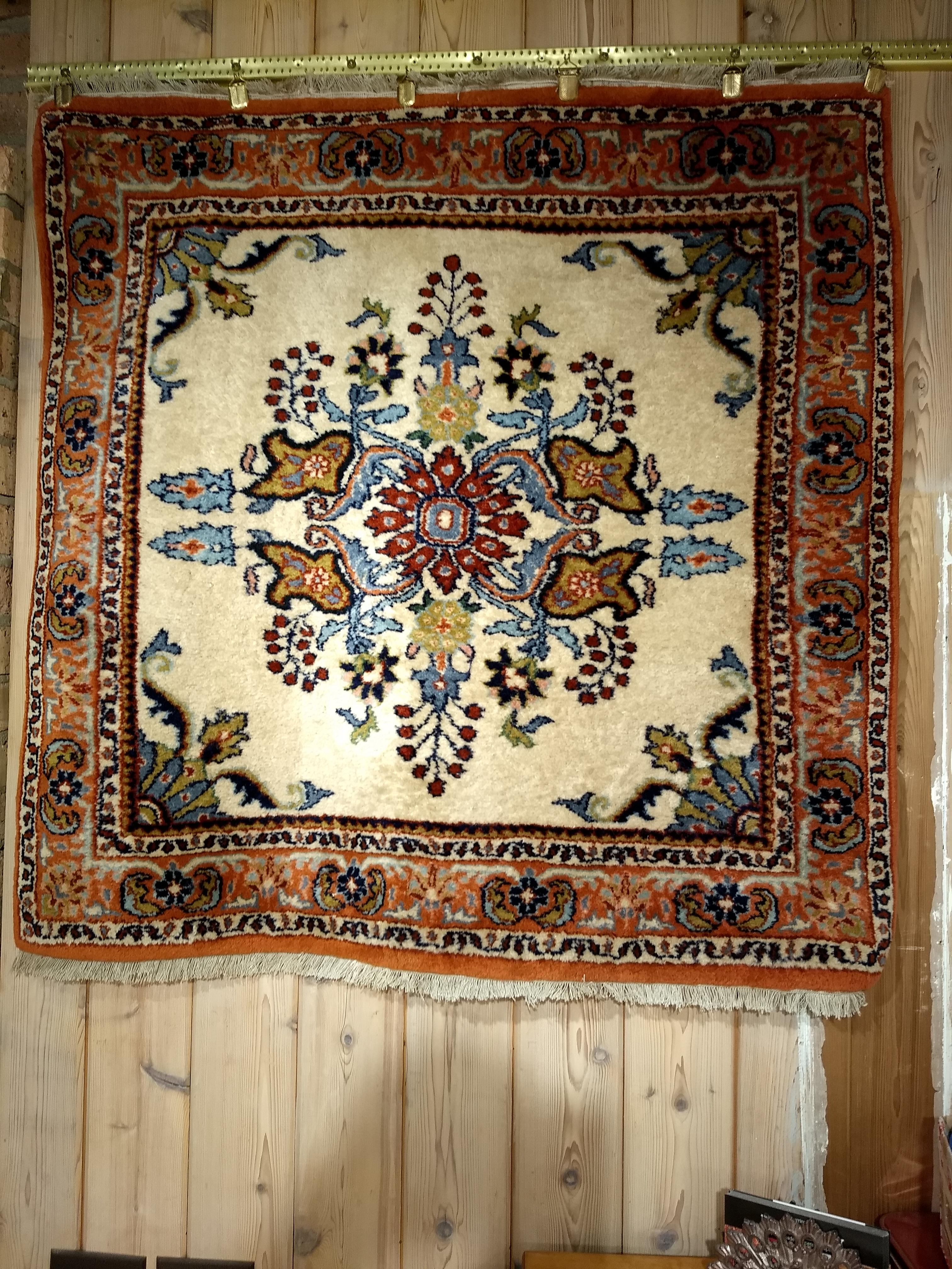 Vintage “square-size” Persian Sarouk area rug in floral pattern with an ivory background.  The rug has an “open design” field with a large central medallion set on an ivory color field with floral design  in baby blue, brown, green, and red.  The