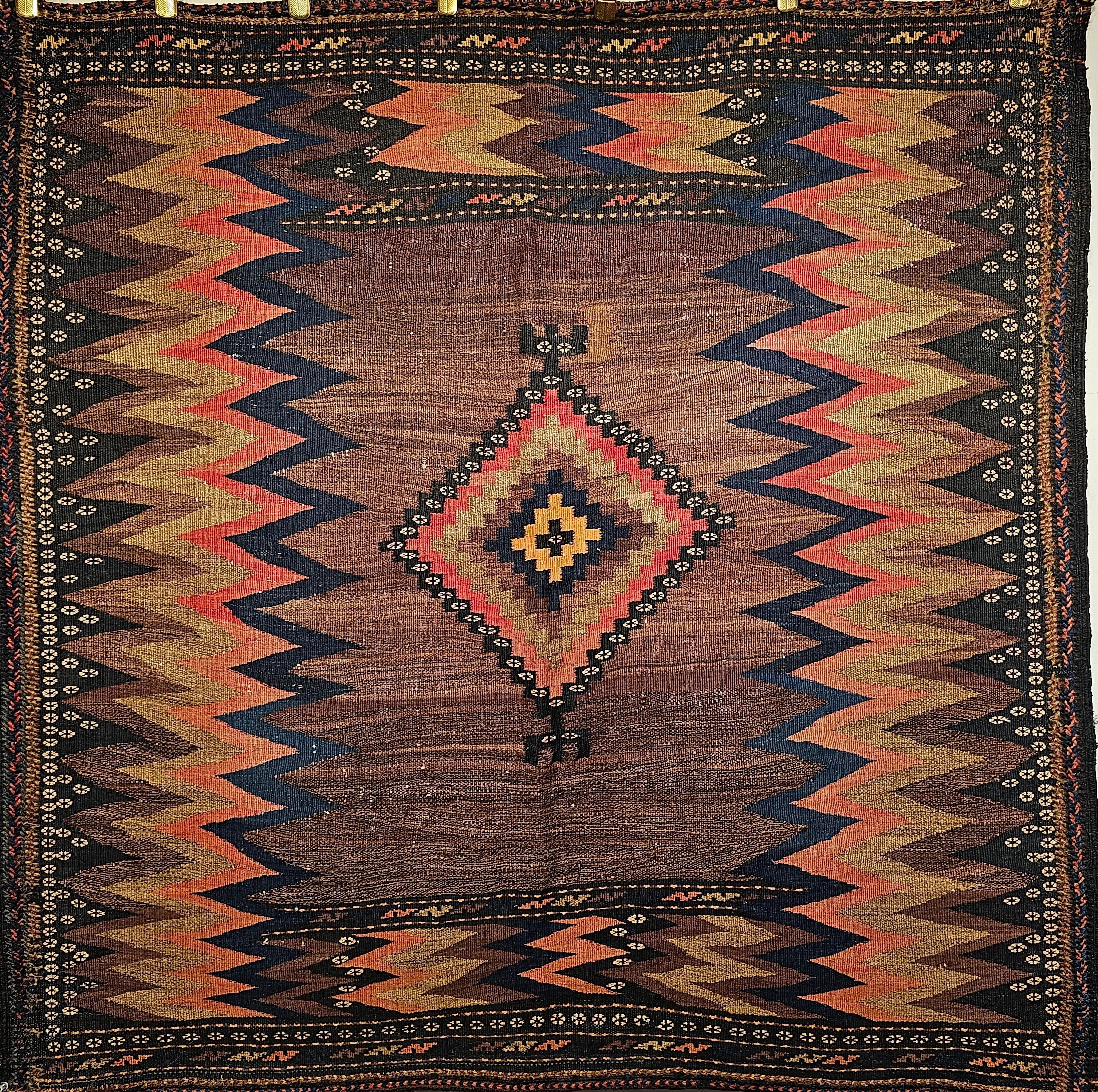  A very rare Persian Tribal Sofreh Kilim from the early 1900s.  The handwoven tribal kilim is from the Qashqai tribes in Southwest Persia.  It is a very desirable square-size tribal kilim with natural organic dyes.  The Sofreh Kilim was mostly woven