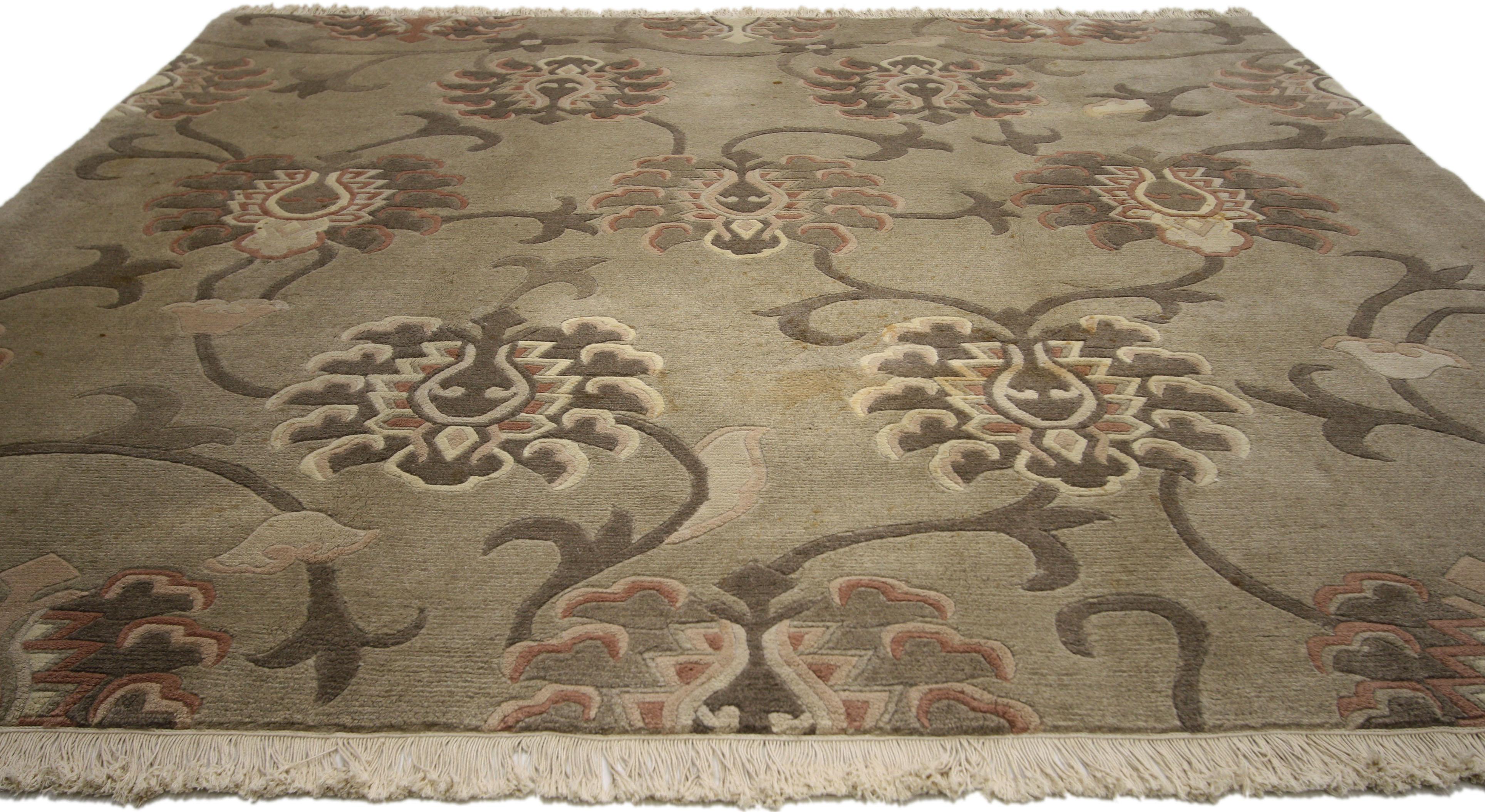 72906, Transitional style square vintage Tibetan rug with large-scale geometric flower pattern. This hand knotted wool Tibetan carpet features a large-scale flower pattern with large blossoming lilies and swirling tendrils on a warm gray backdrop.