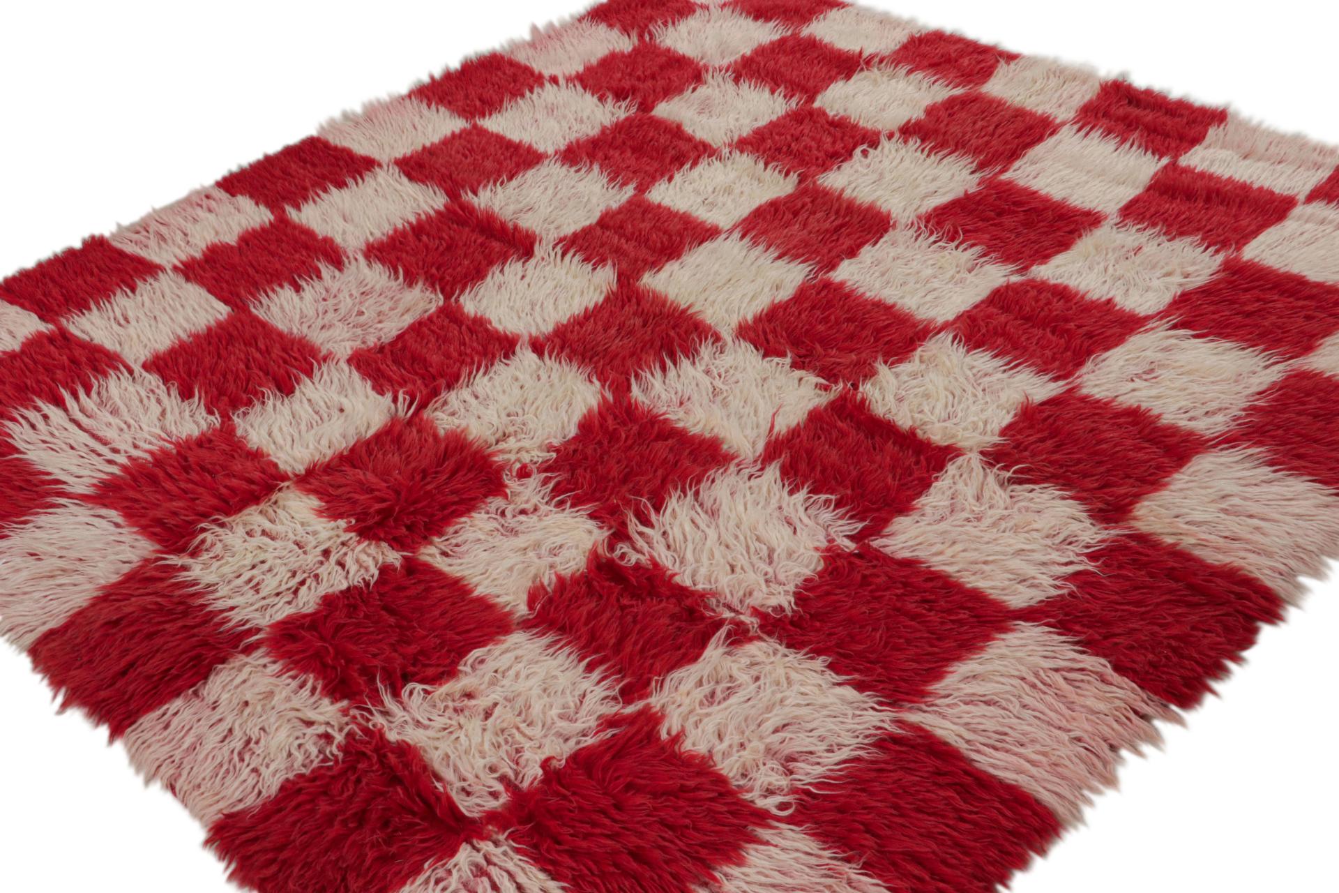 Hand-knotted in wool, this 7x7 vintage Tulu rug, circa 1950-1960, is among the family of Tulus with minimalist checkered geometric patterns, as seen in the rich red and pink squares.  

On the Design: 

Tulus are some of the most sought-after