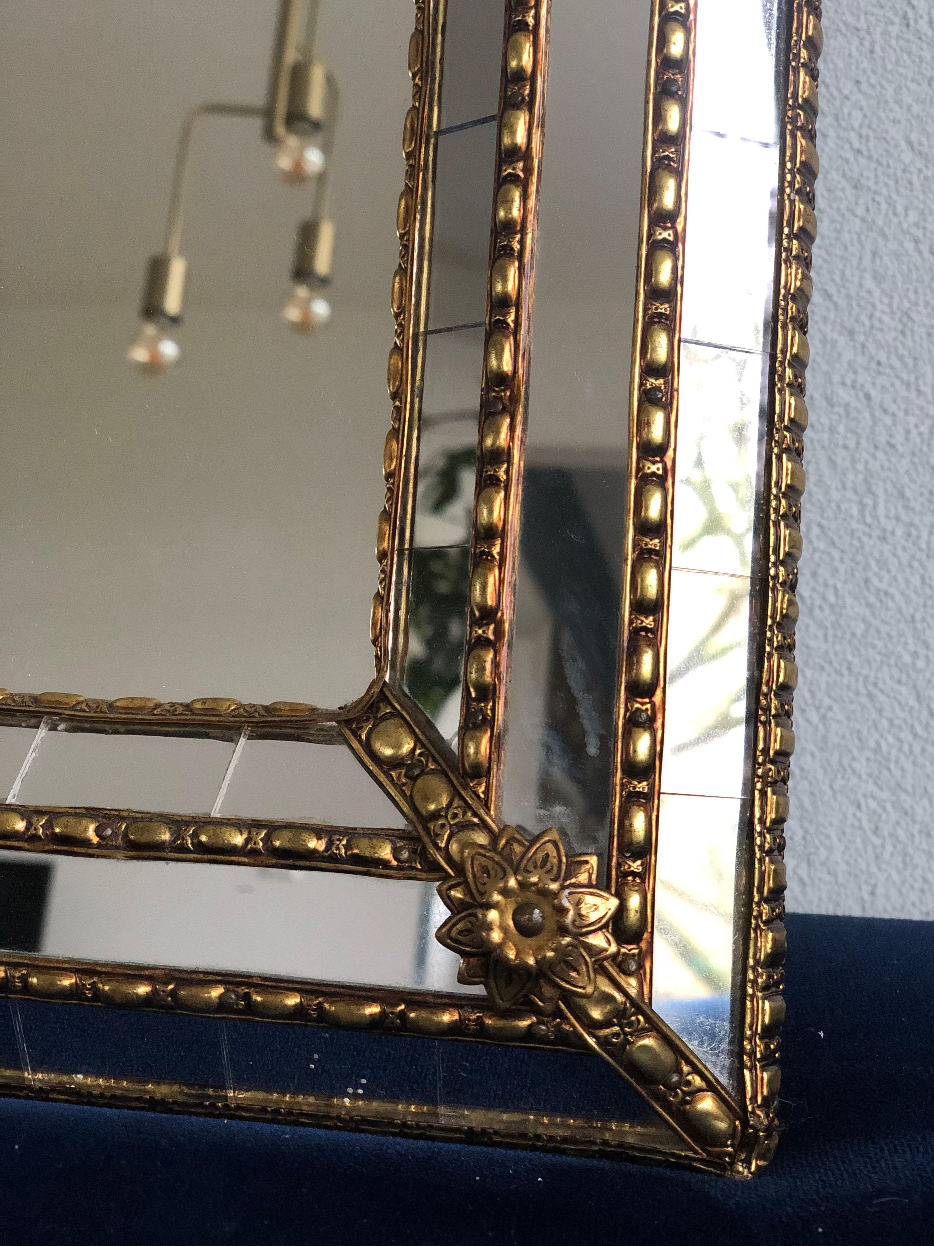 Beautiful Spanish square mirror with a Venetian glass frame with a brass golden strip. The frame is made with small crystals both on the outside and inside, and larger ones in the center line. The brass strip holds the mirrors together.

Handmade