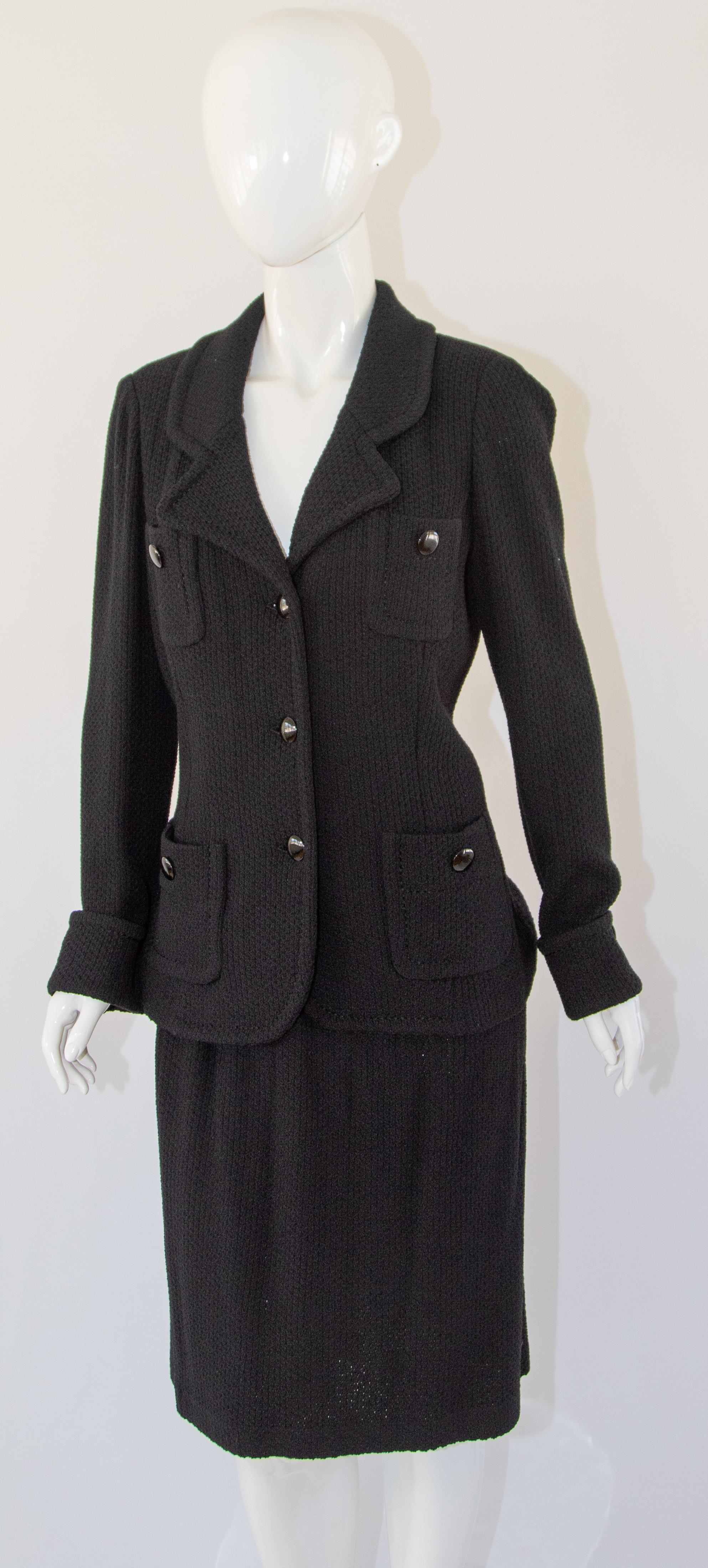 Vintage St John Caviar Black Knit blazer and skirt suit.
St John Caviar Black Wool Jacket with St John Black Wool skirt
Black wool unlined jacket and skirt.
Turned up cuffs
Four functioning patch pockets on jacket,
Button closure on jacket, elastic