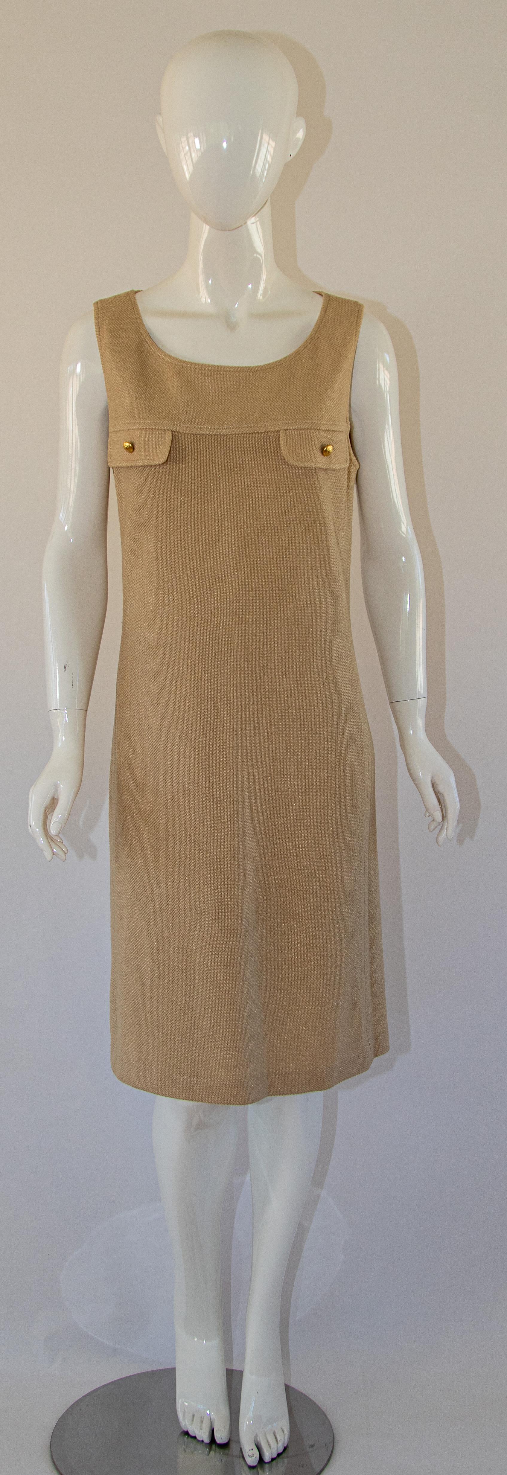 Vintage St John collection by Marie Gray Knit mini dress.
St John beige wool knit unlined sleeveless mini dress classic chic.
Two false patch pockets with gold buttons, zipper in back.
Size 8 US
Made in USA.
Measurements:
Bust-36