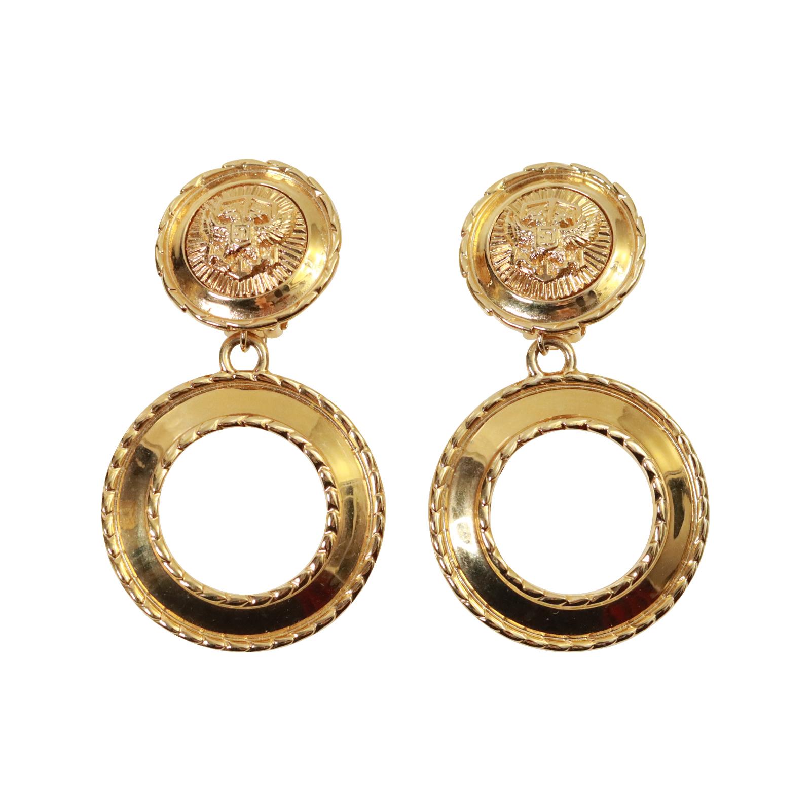 Vintage St John Gold Tone Hoop Earrings Circa 1980s. St John made some great jewelry in the 1980s.  These dangling gold hoops look so chic and stunning with everything. They have a medallion crest on the top part.  So reminiscent of the 1980's.