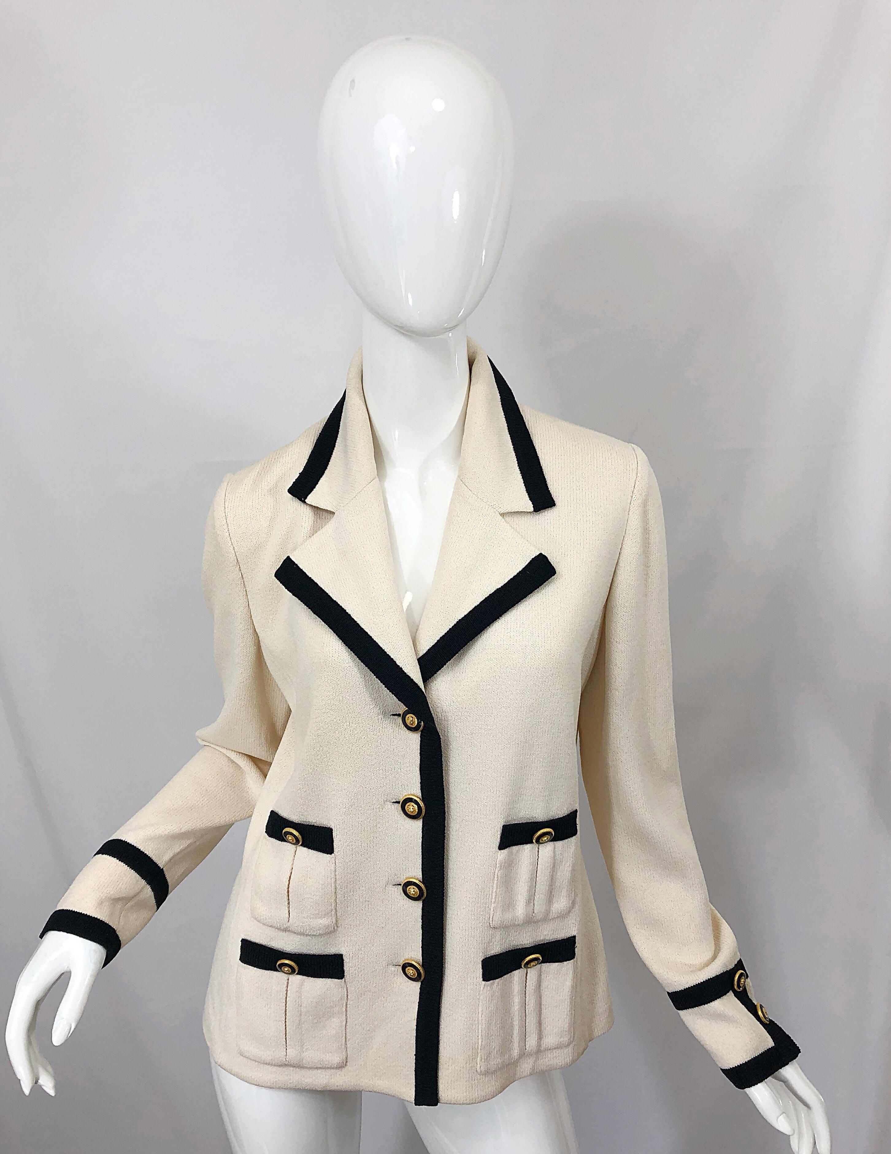 Chic and classic vintage ST. JOHN 1990s ivory and black santana knit blazer jacket! Features four black and gold buttons up the front and at each sleeve cuff. Black trim throughout. Comfortable stretch knit that looks great on, and is super