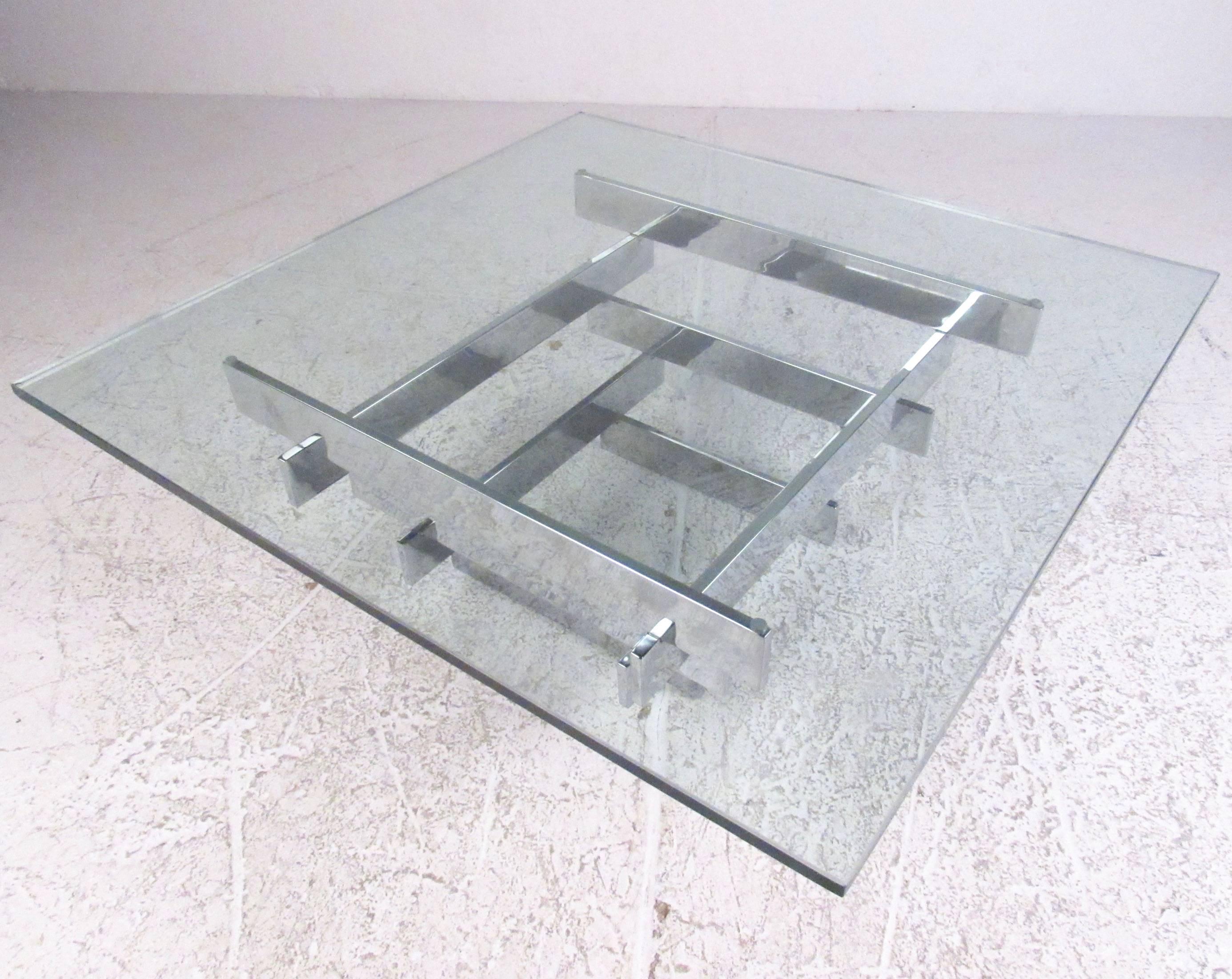 This unique Mid-Century Modern chrome coffee table features stacked chrome slat table base with thick glass top. The stylish vintage design is in the style of the 