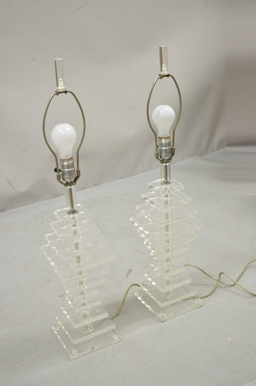 Vintage stacked Lucite Mid-Century Modern table lamps - a pair. Item features stacked lucite forms, lucite finials, very nice vintage pair, clean modernist lines, great style and form. Circa mid 20th century. Measurements: 30