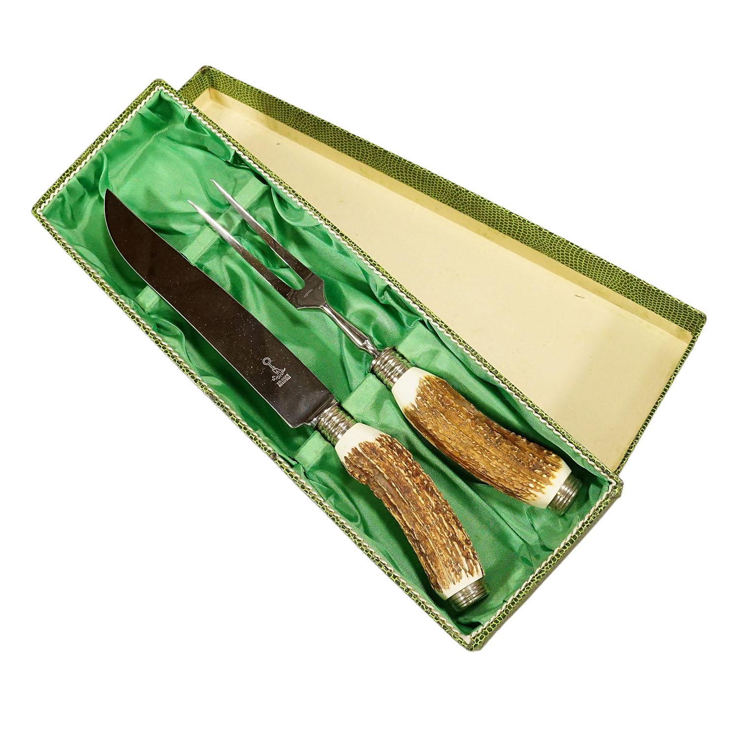 Vintage Stag Horn Carving Set Solingen, Germany

A rustic carving set consisting of fork and knife. The handles are made of genuine stag horn and feature a silver knob on their ends. Blade and fork made of stainles steel. The set comes with its