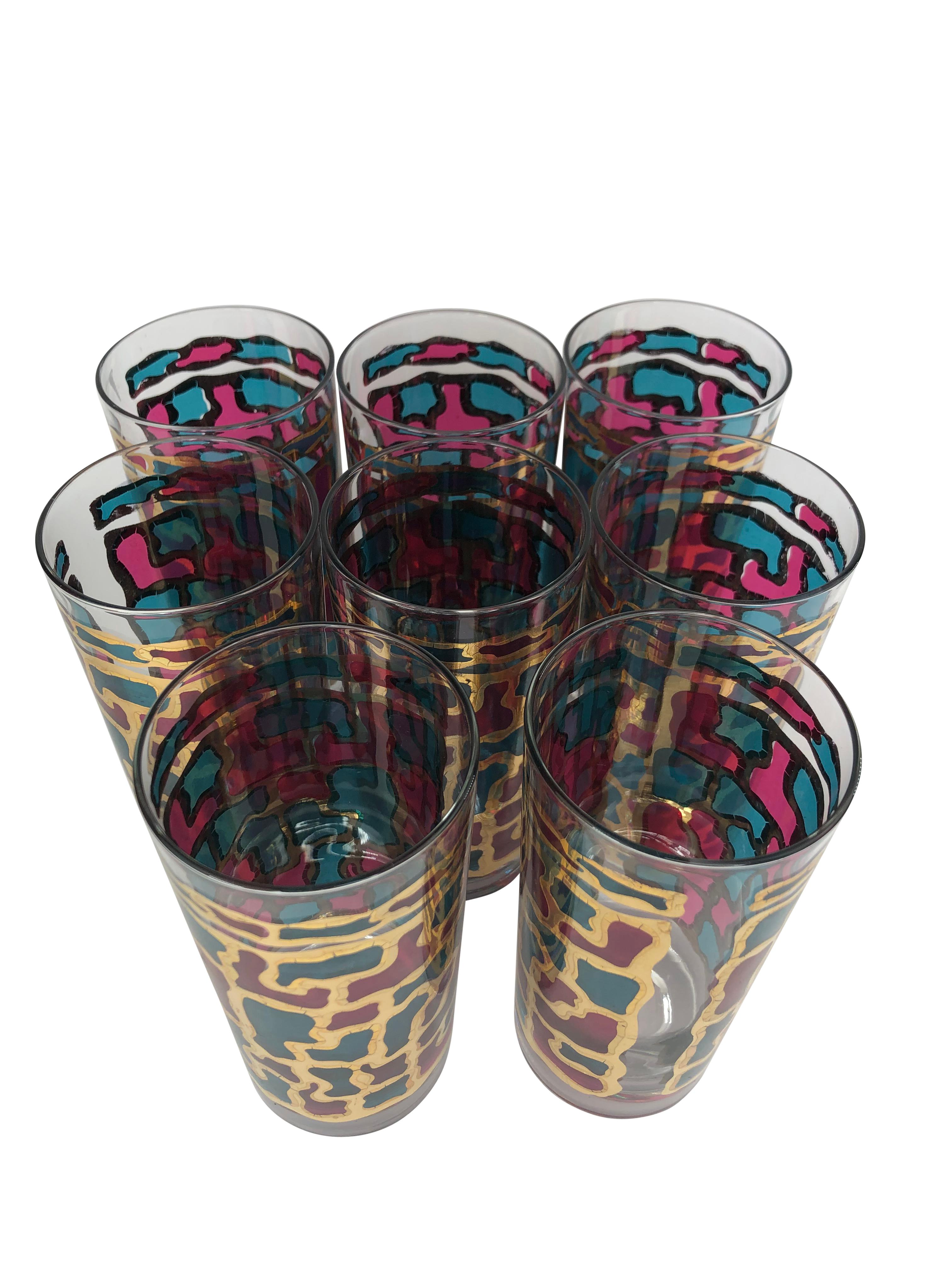 Set of 8 Vintage Blue and Fuchsia Stained Glass and Gilt Highball Glasses. Colorful panels framed on 22k gilt decoration. Glasses measure 5 1/2
