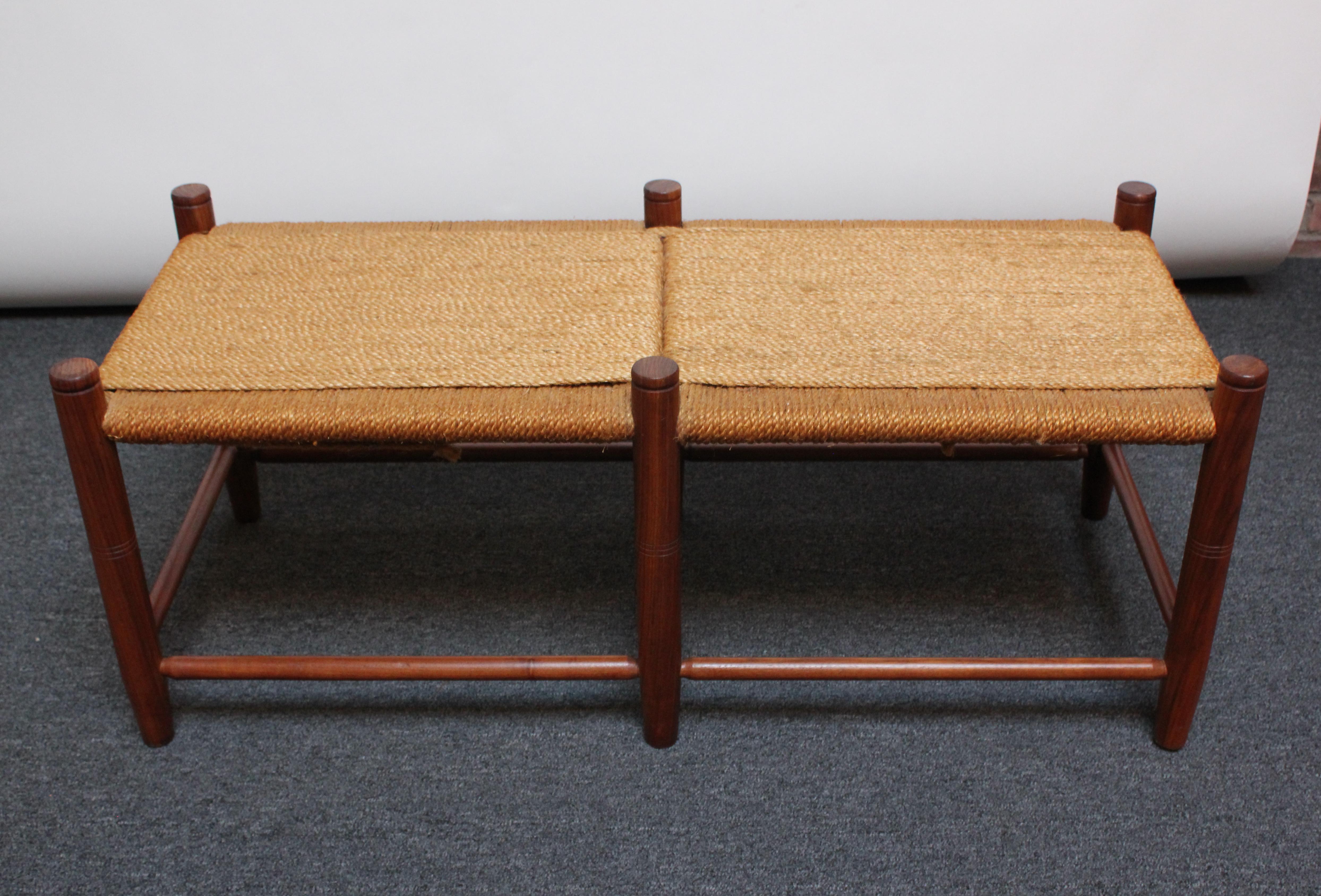 Solid teak bench with woven rope seat (ca. 1970s / 1980s, USA). Teak has been conservatively refinished; rope is in very good, original condition.
Measures: H: 18.75