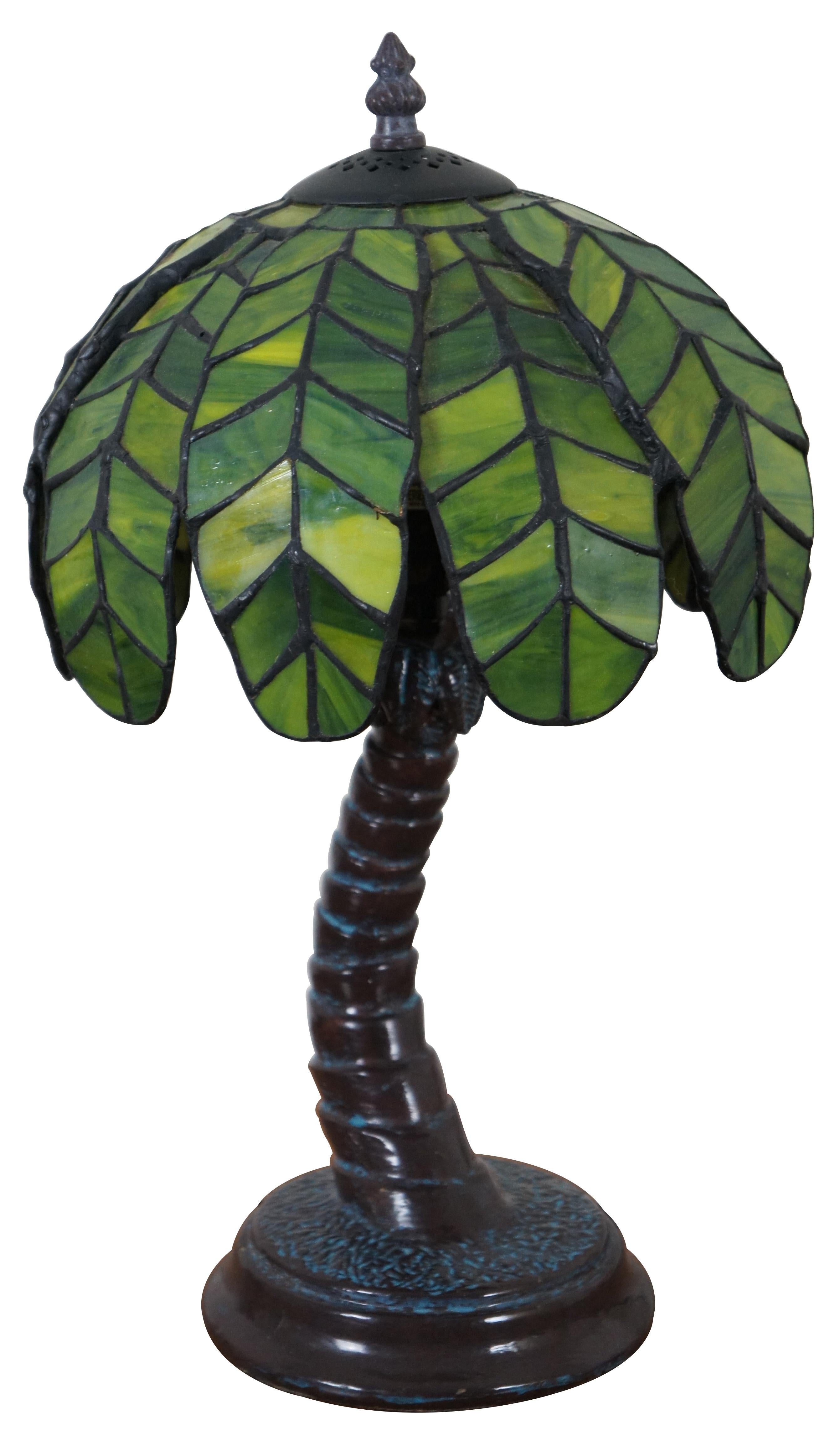 Vintage table lamp in the shape of a curved palm tree with a dark brown trunk, topped with a Tiffany style 150 piece slag / stained glass shade of palm fronds / leaves.