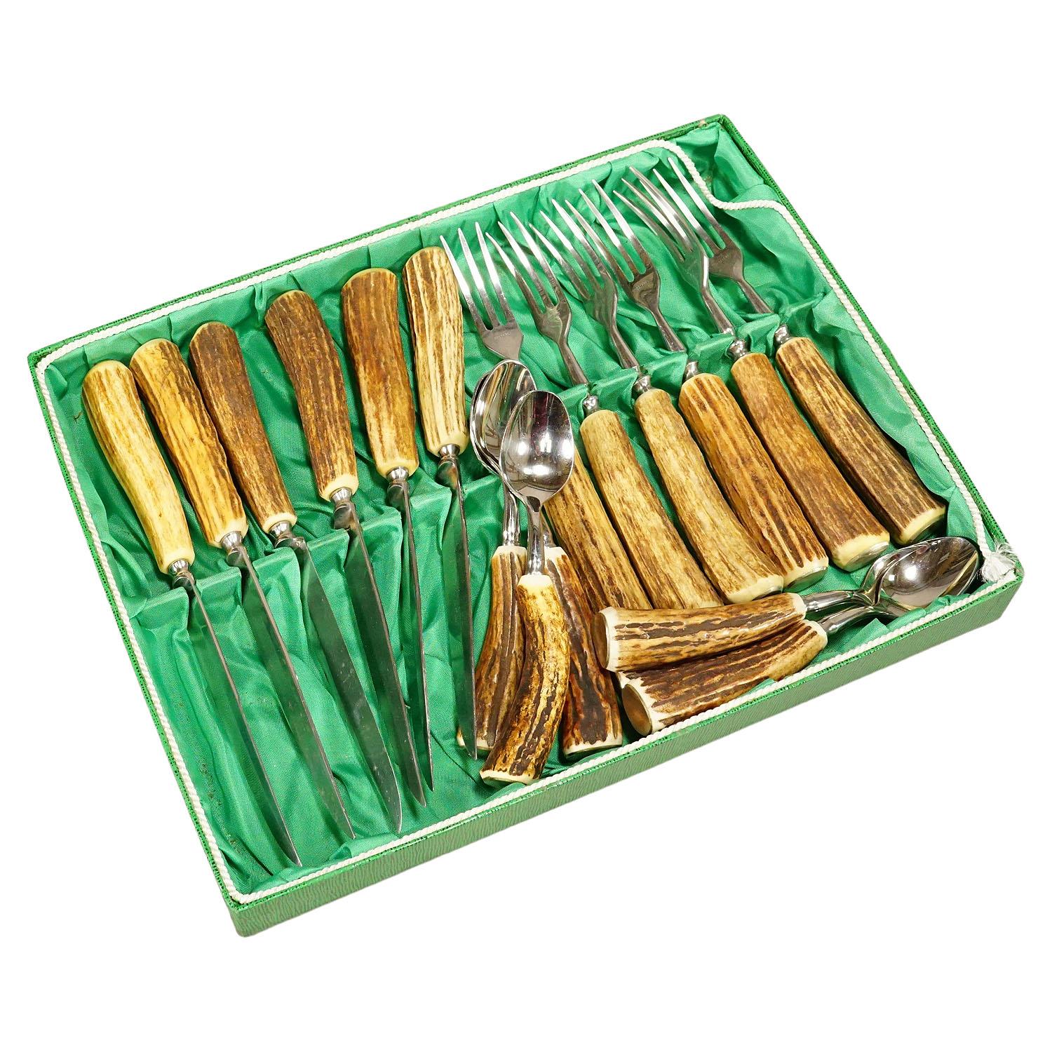 Vintage Stainless Steel and Horn Tableware 18 Pieces Set Solingen, Germany

A rustic tabelware set consisting of six steak knives, forks and spoons. The handles are made of genuine deer horn and feature a silver knob on their ends. The blades are