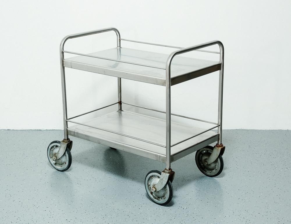Vintage industrial cart in stainless steel on large rubber casters. Perfect as a bar cart or small kitchen island.