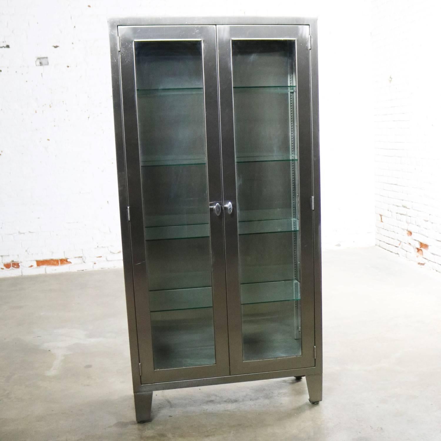 Incredible industrial stainless-steel medical or apothecary cabinet with glass doors, sides, and shelves that allow it to make the best display cabinet ever. It is in exceptional vintage condition. Any imperfections, i.e. scratches and dings, are