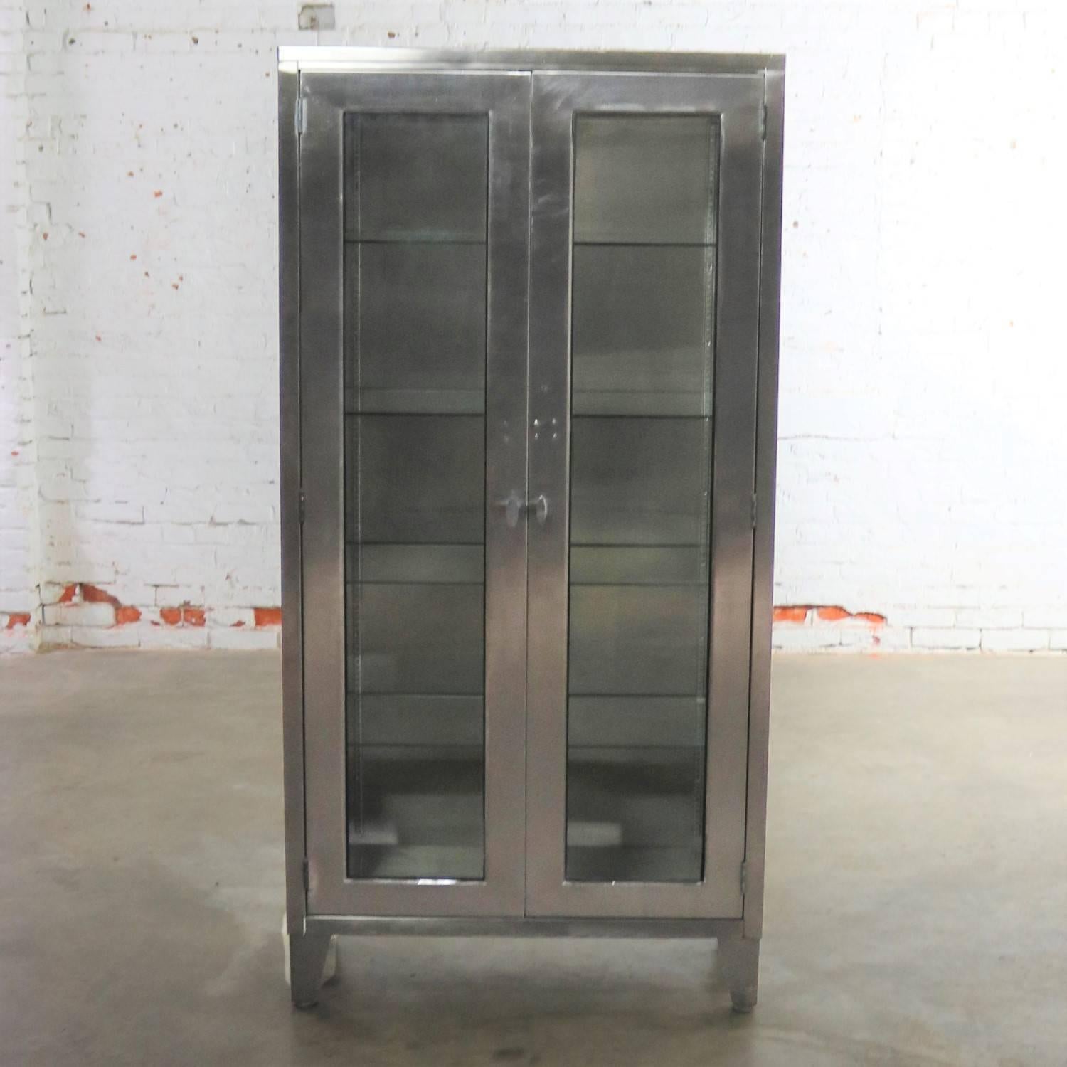 Incredible industrial stainless-steel medical or apothecary cabinet with glass doors, sides, and shelves that allow it to make the best display cabinet ever. It is in exceptional vintage condition. Any imperfections, i.e. scratches and dings, are